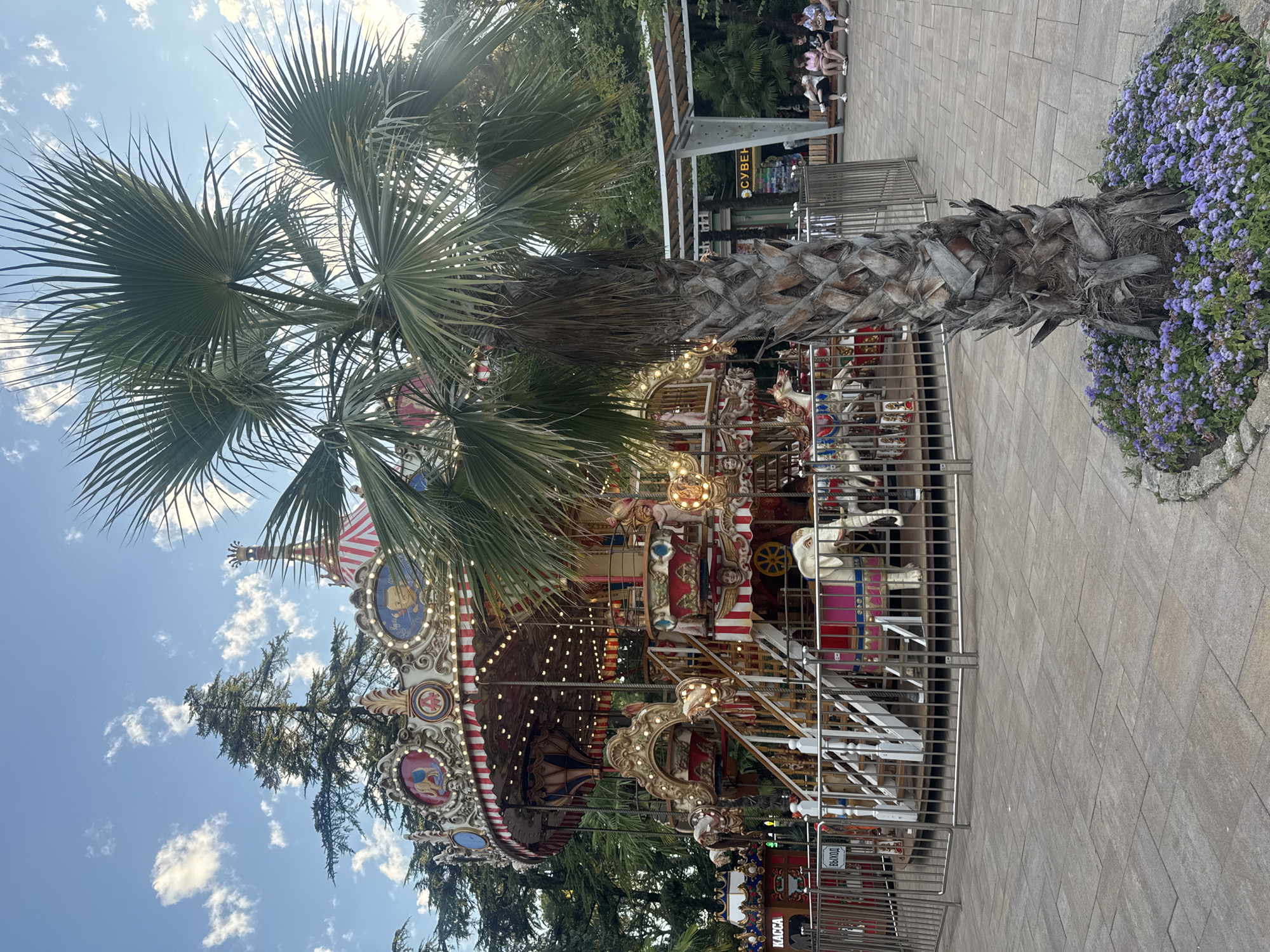 Carousel, snacks, and giant finger sculptures at a Sochi amusement area