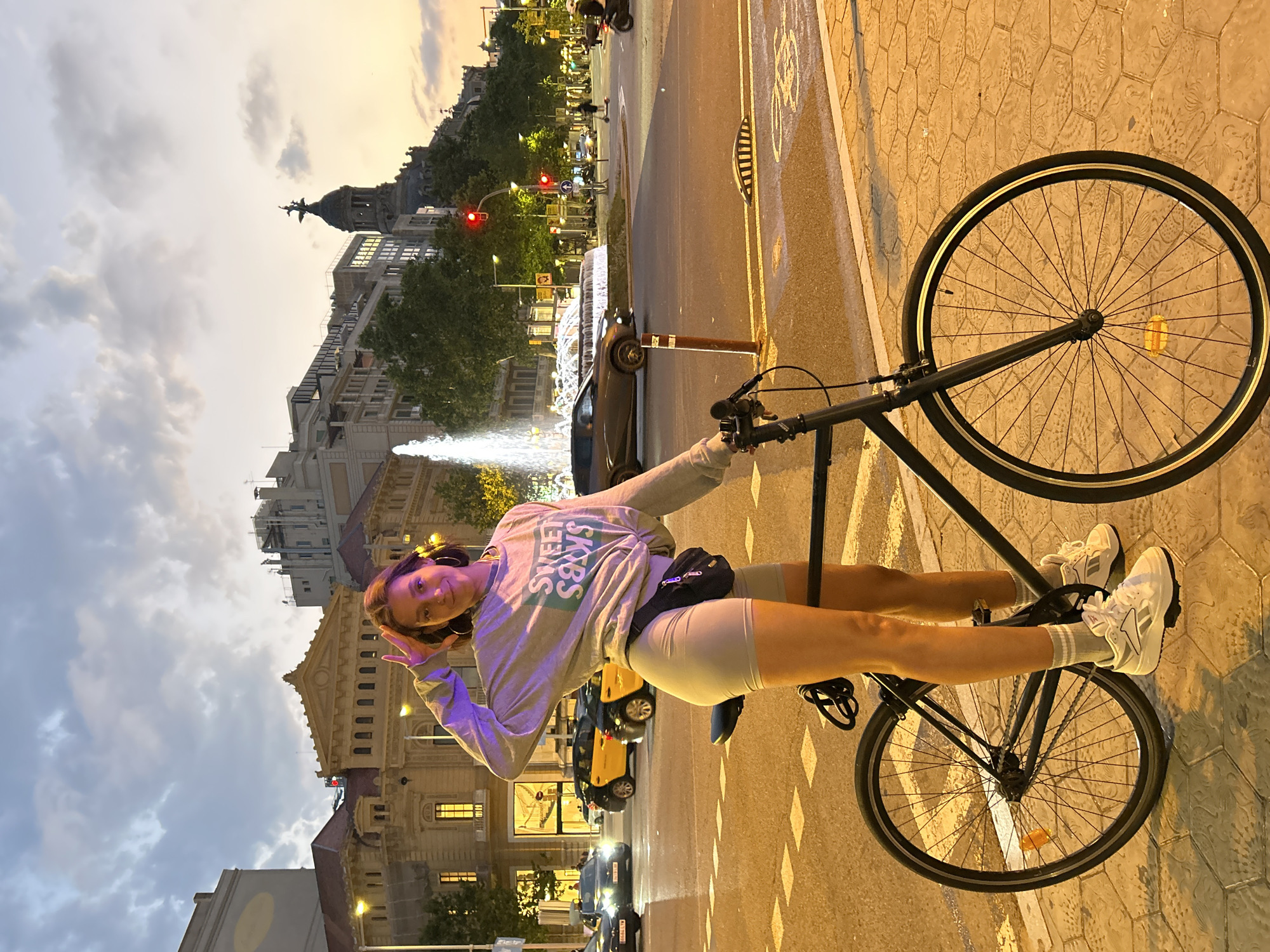 Woman with bicycle spotted at Barcelona intersection during dusk