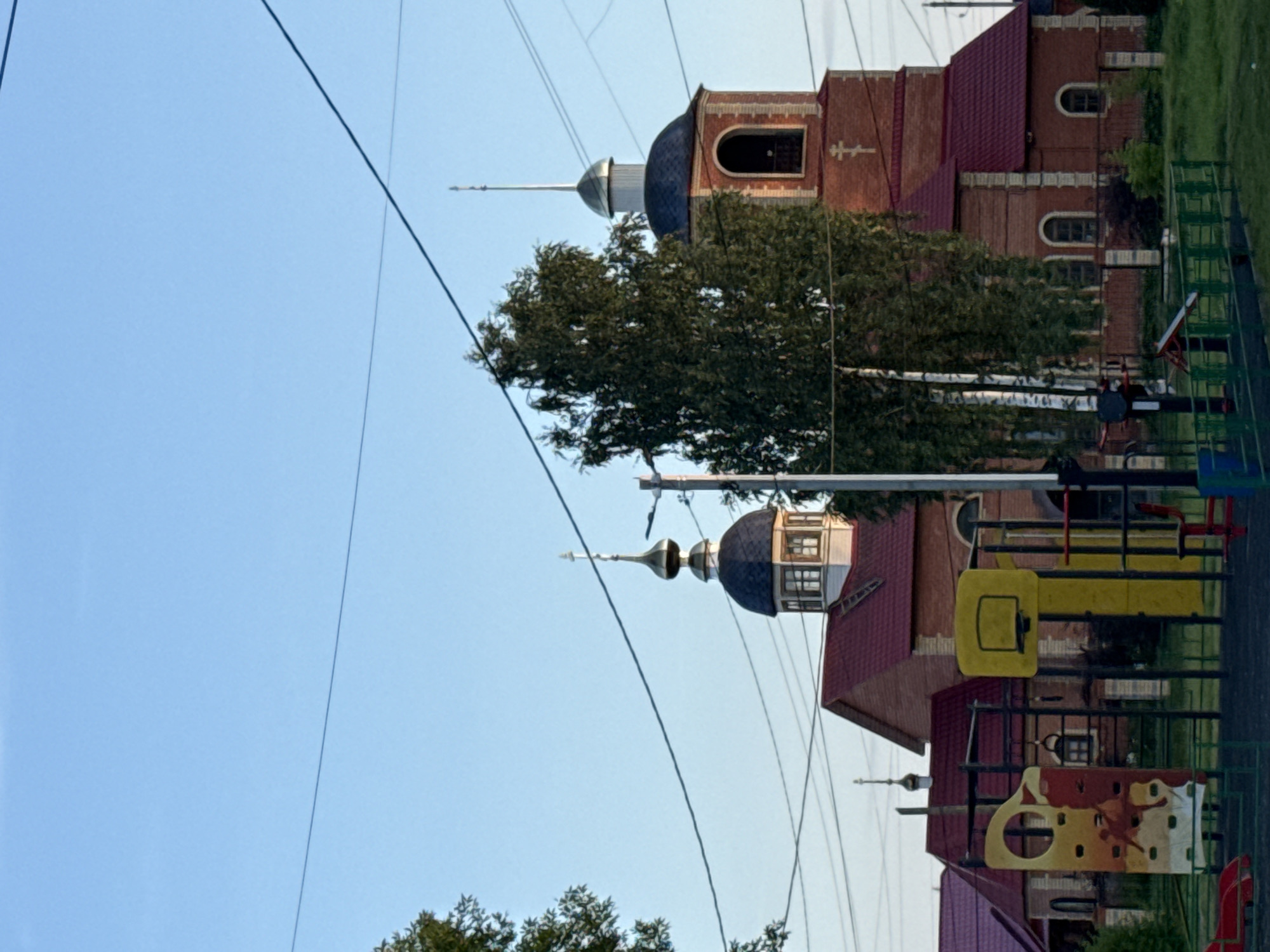 Golden hour across Vetluzhsky streets and an Orthodox church
