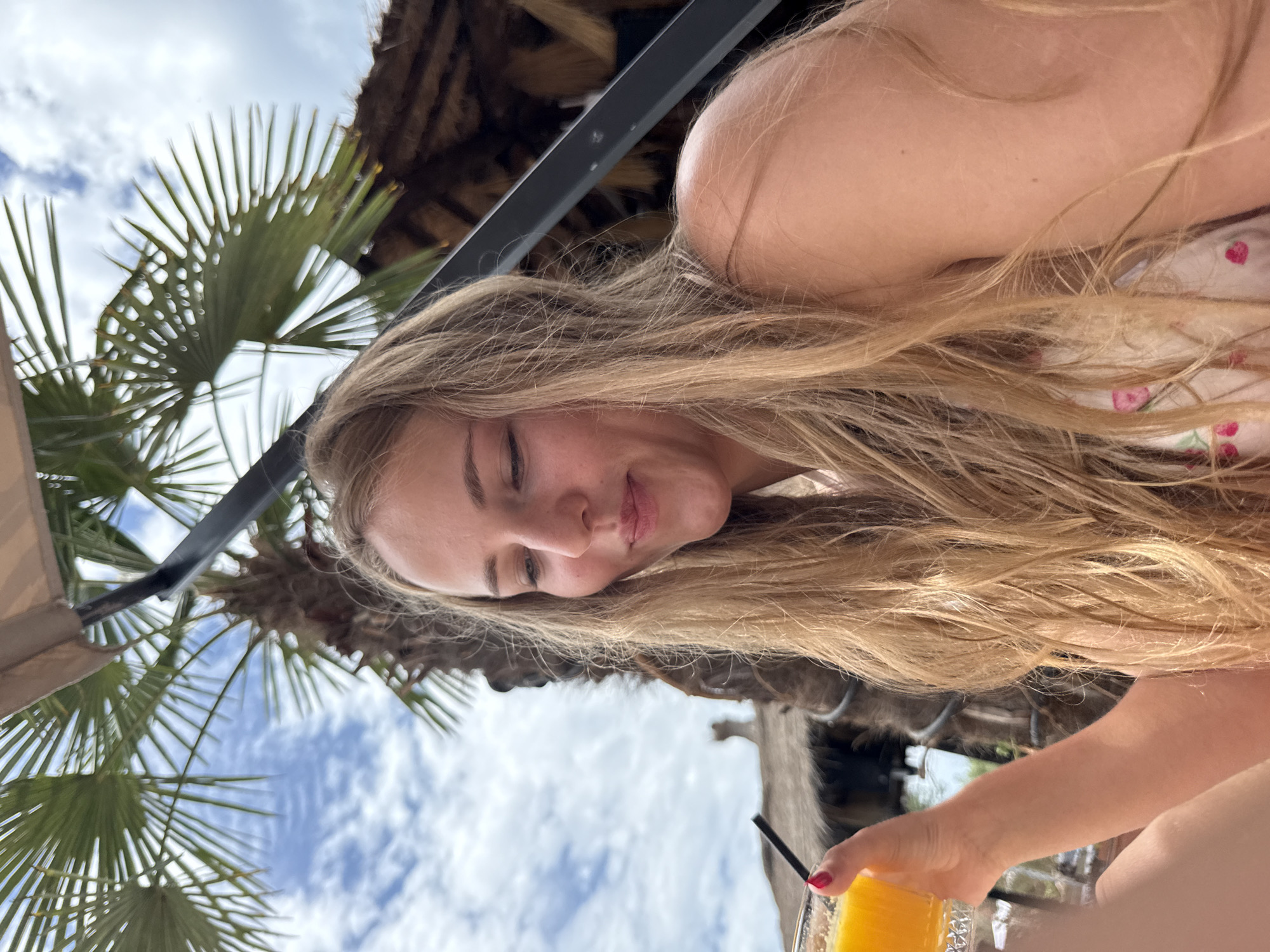 Relaxing with orange juice at a Vlora beach bar