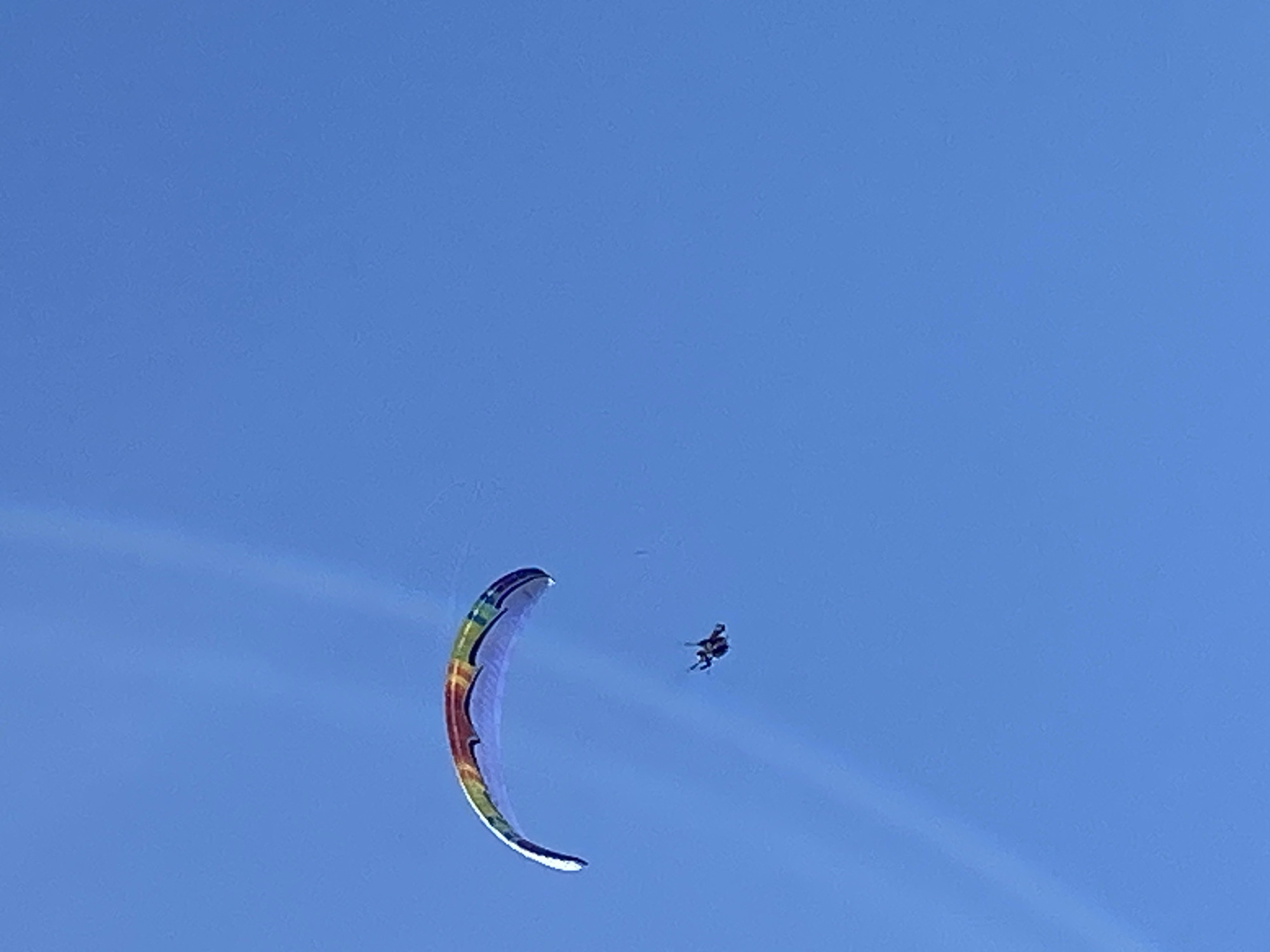Paraglider soars over Boreti, Montenegro in clear skies
