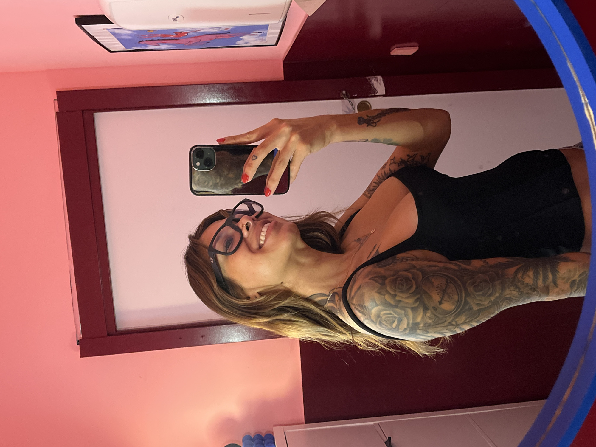 Mirror selfie in a pink Barcelona bathroom, June 2026