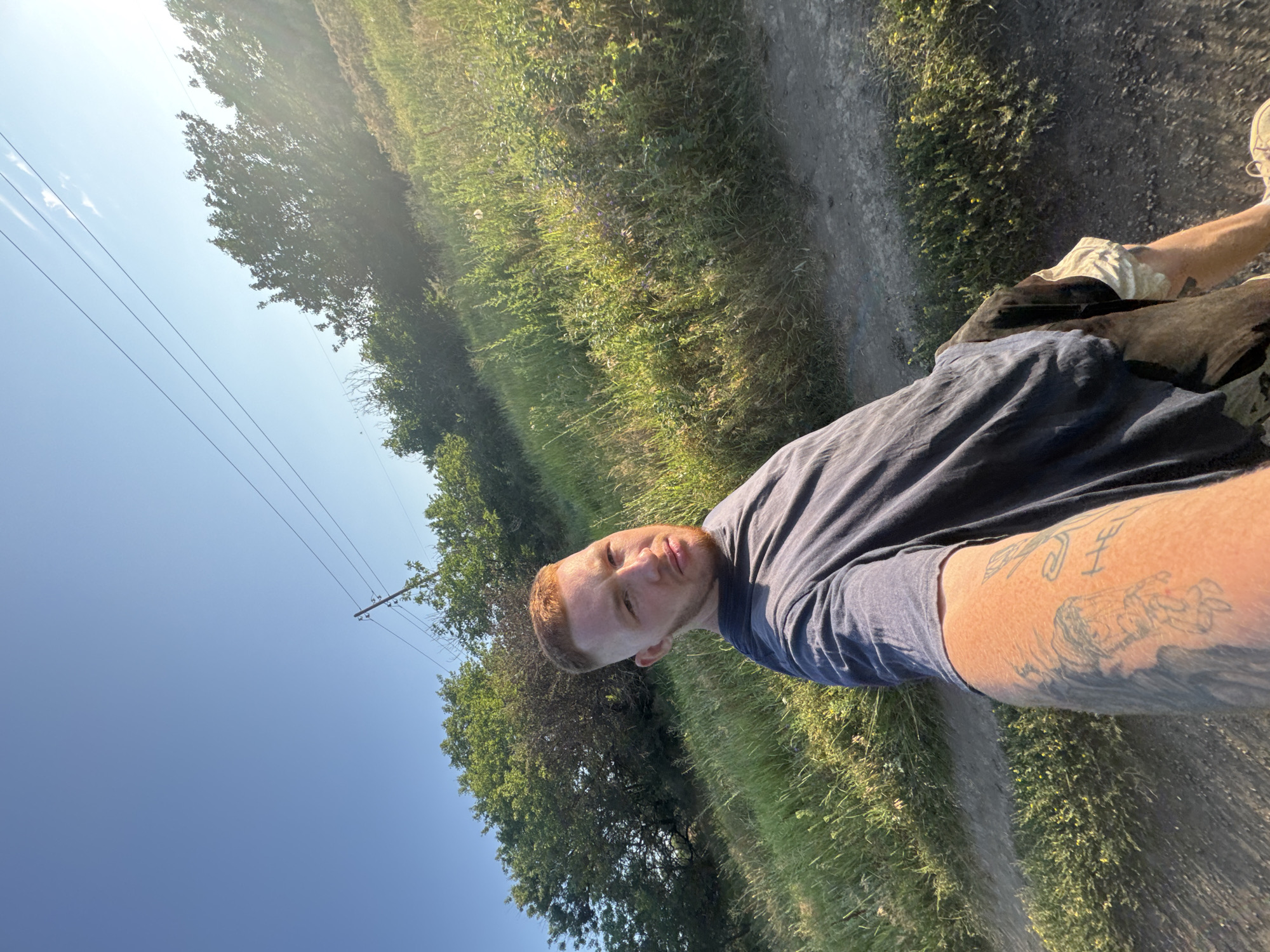 Selfie session on a rural dirt road under clear skies