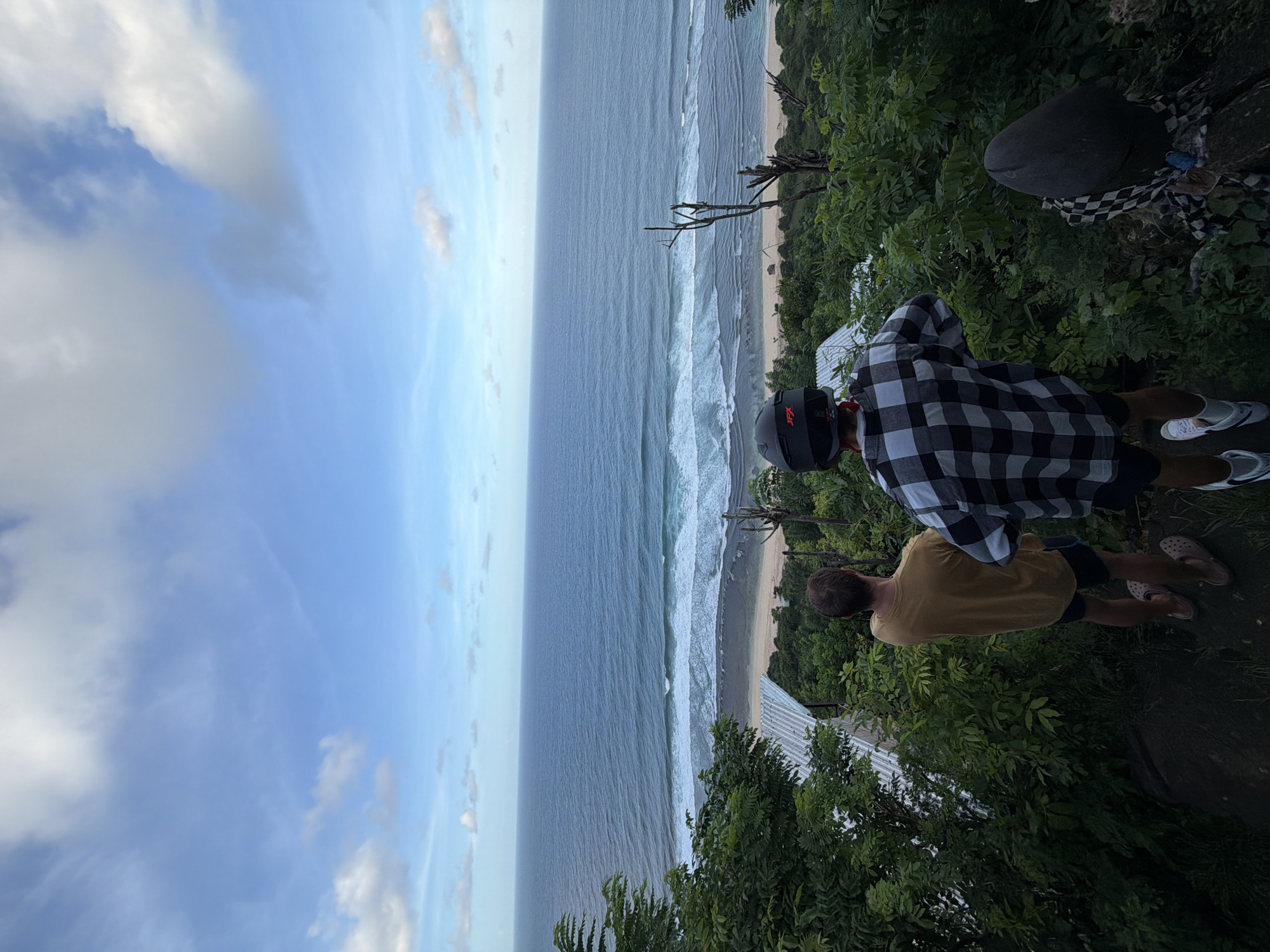 Two men visit monkey-populated oceanfront viewpoint in Kuta Selatan