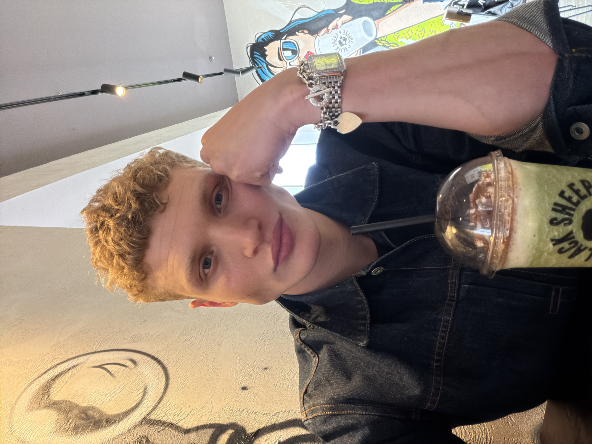 Coffee shop patron enjoys matcha latte at London cafe