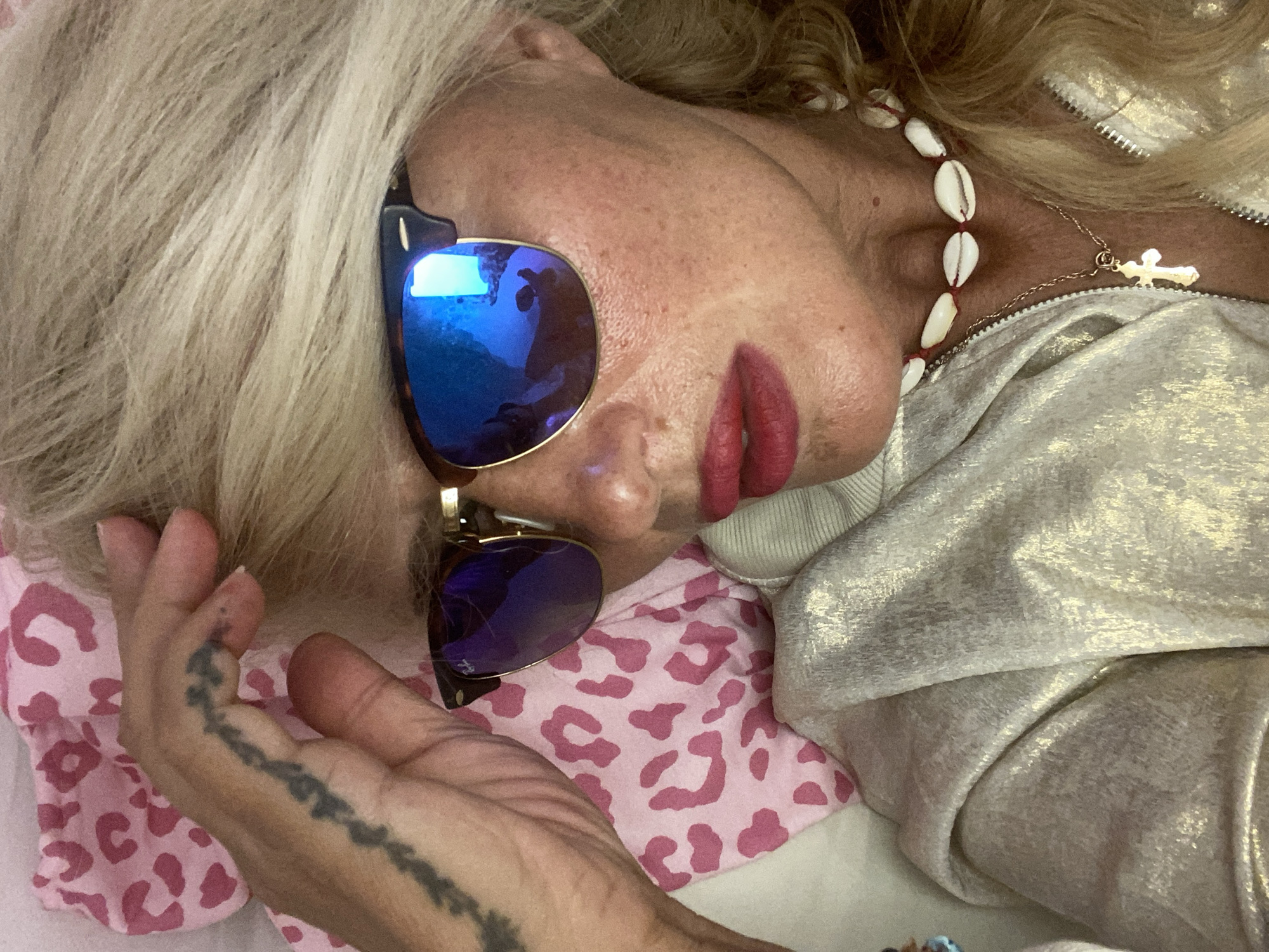 Relaxed Santorini afternoon, shell necklaces and mirrored shades