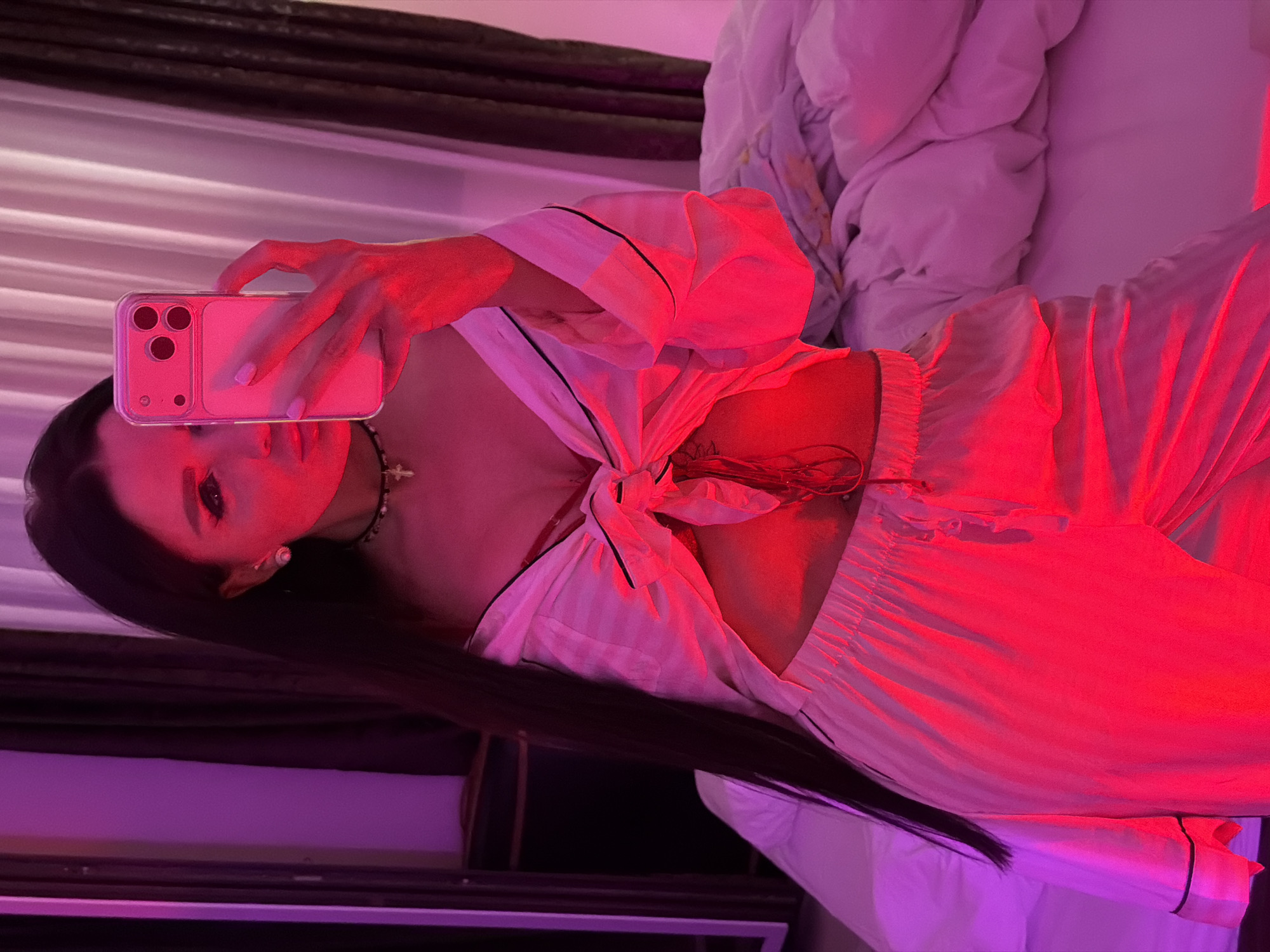 Mirror selfie taken in colorfully lit room in Montenegro