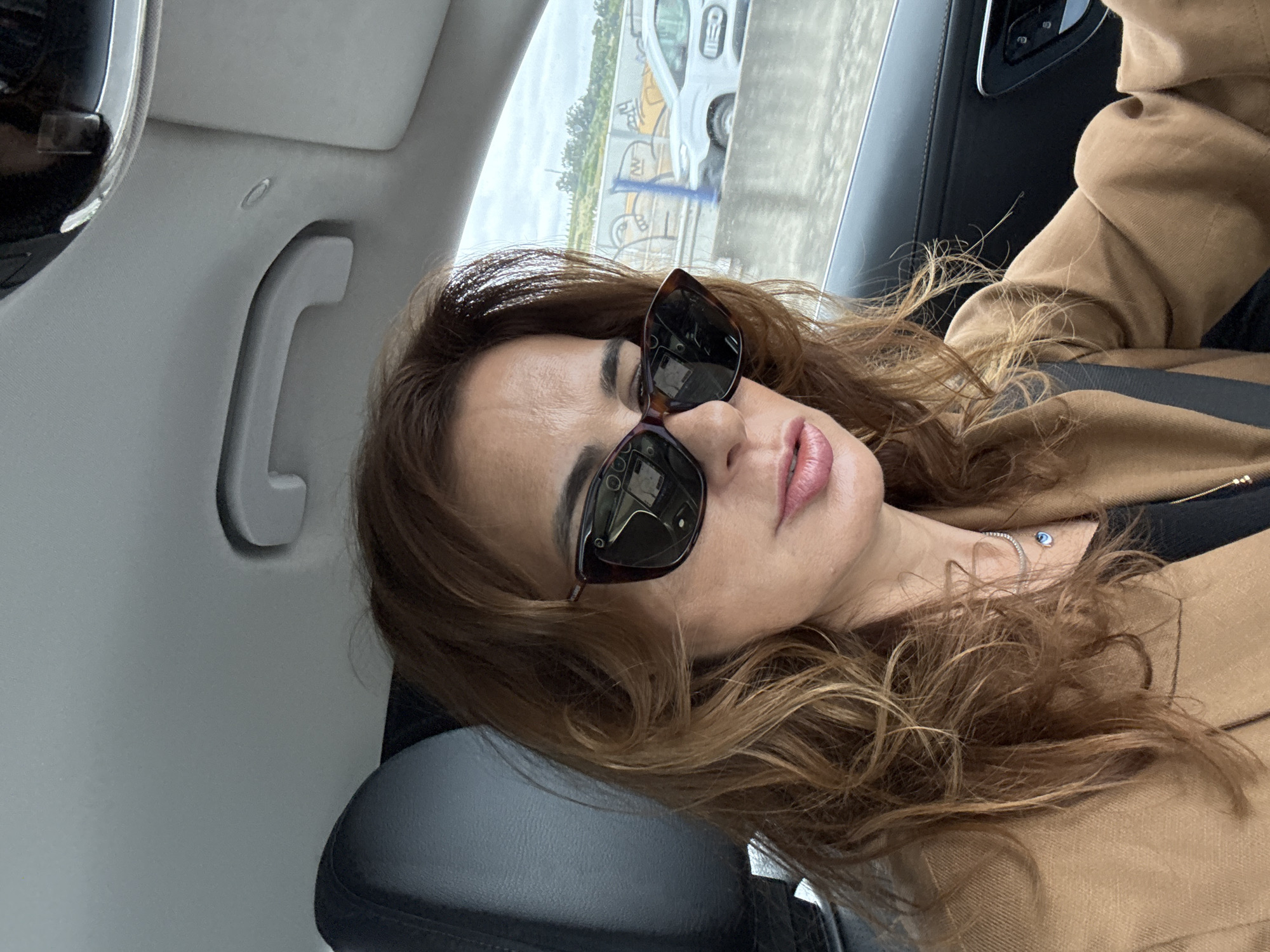 Woman photographed in car passenger seat in Loures