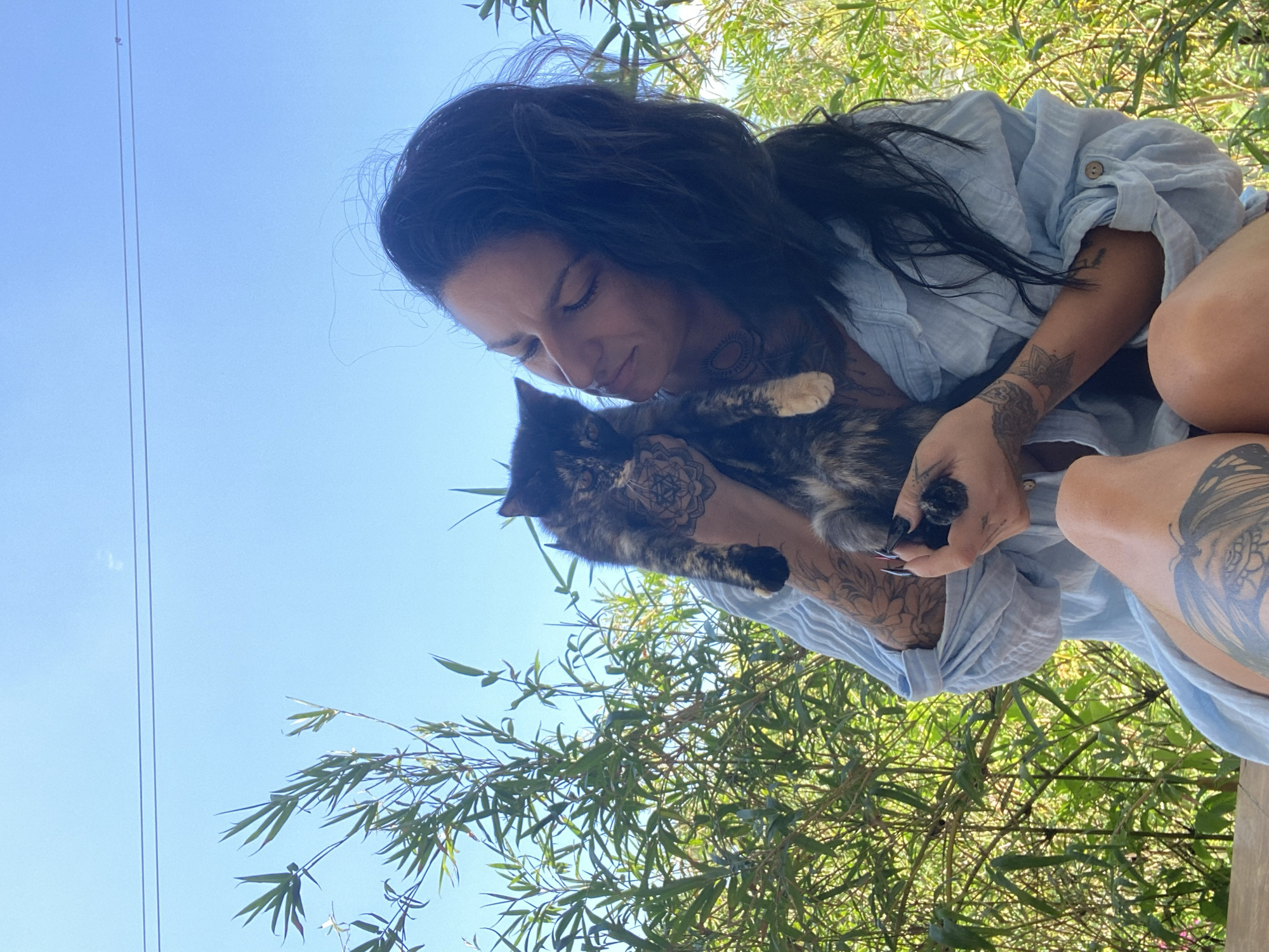 Tattooed woman photographed with cat in Mũi Né, Vietnam