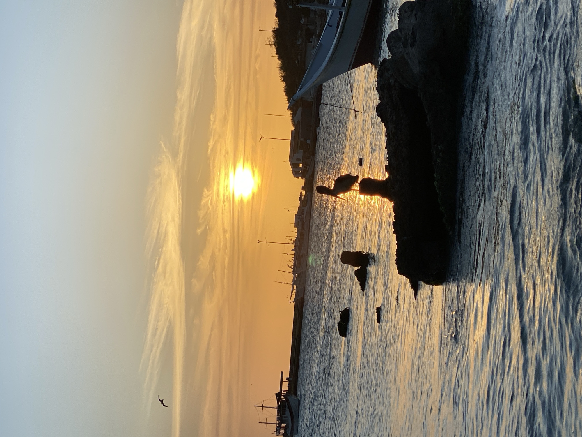 Sunset documented at Juan Griego harbor with fishing vessel