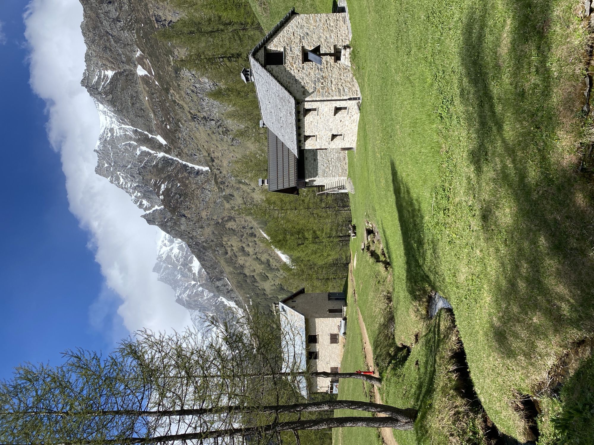 Hiker documents alpine scenery, trail markers in Baceno, Italy
