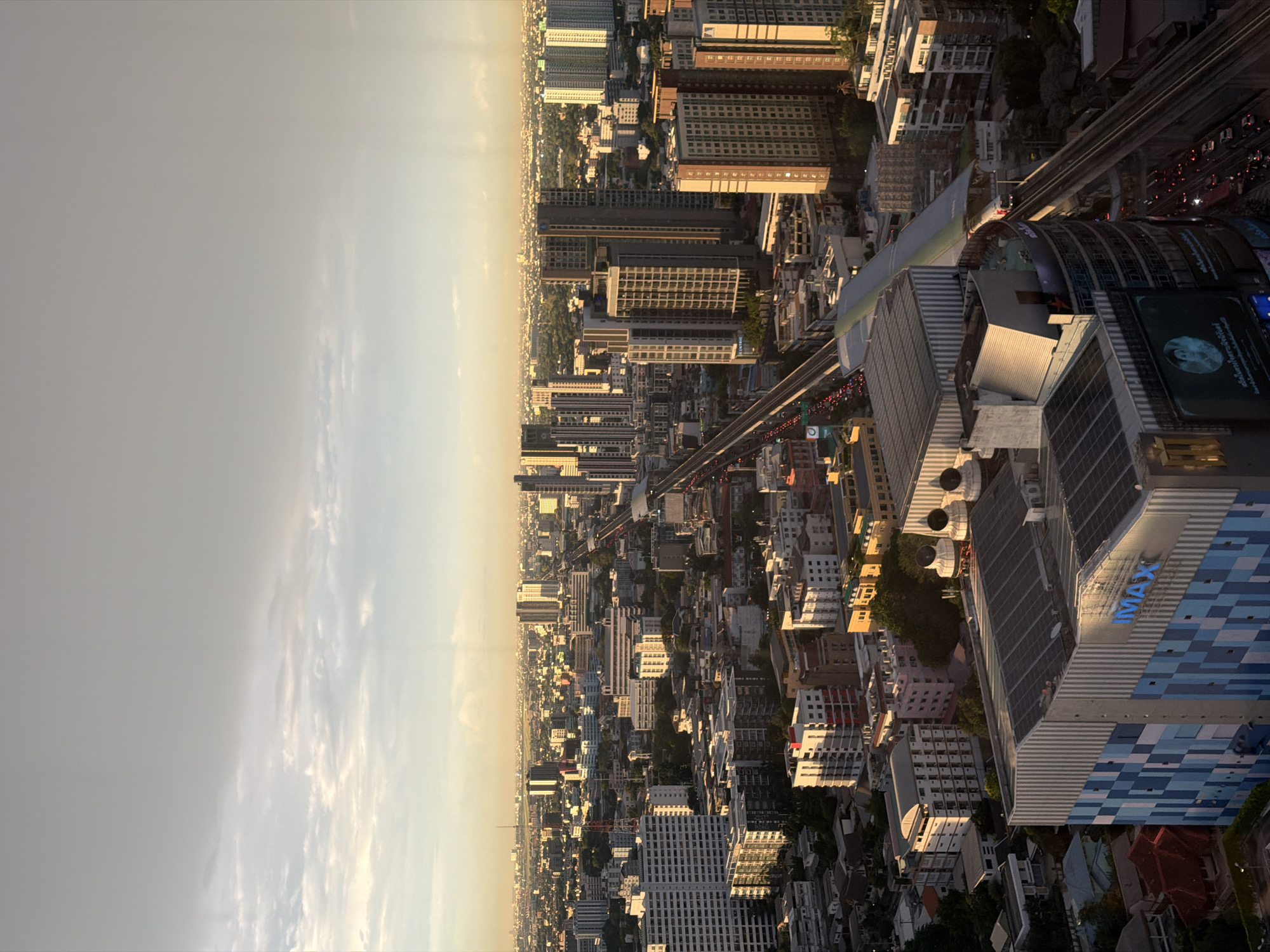 Bangkok cityscape from above, glowing in hazy golden light