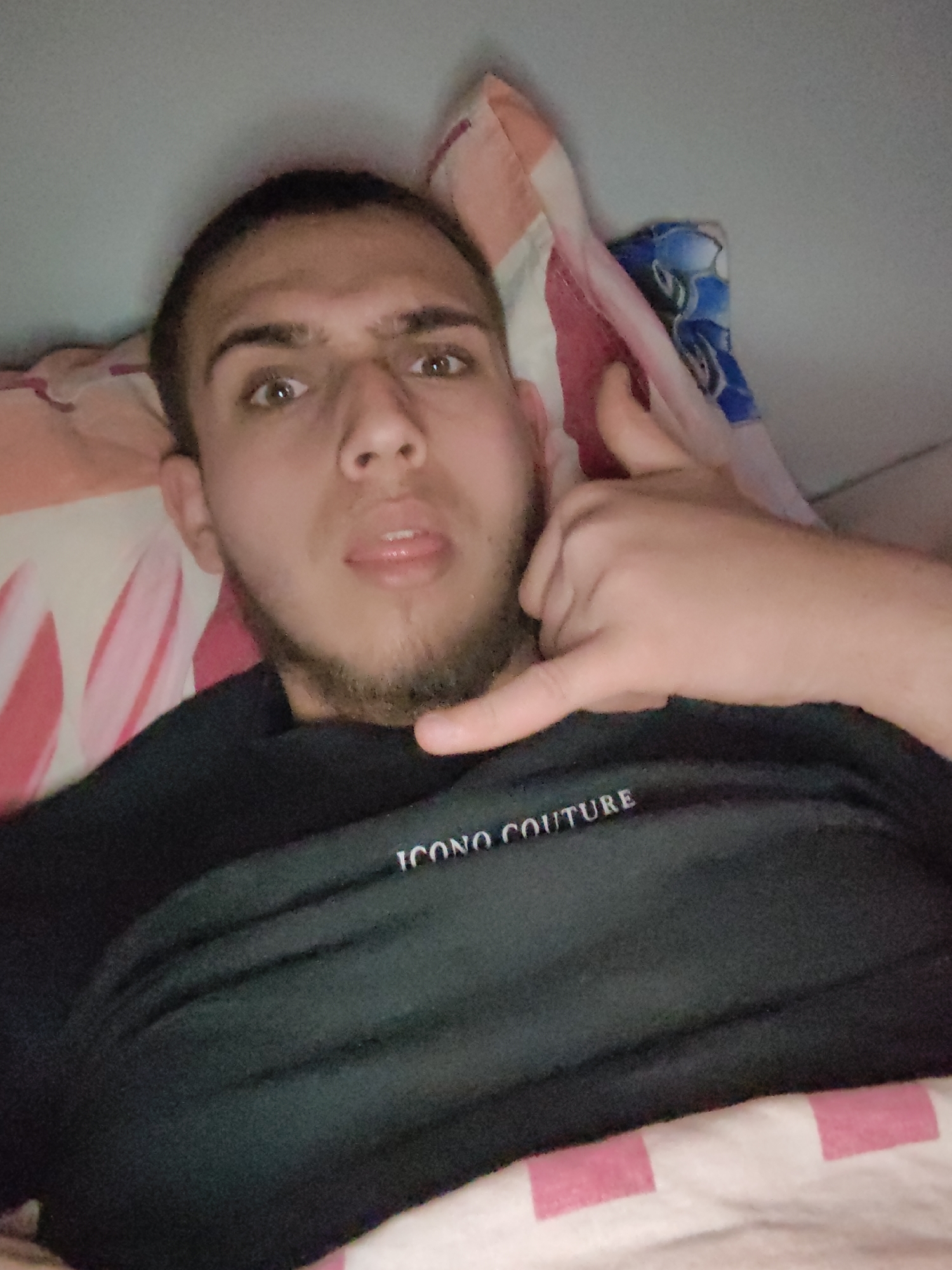 Young man poses playfully with bananas in Sofia bedroom