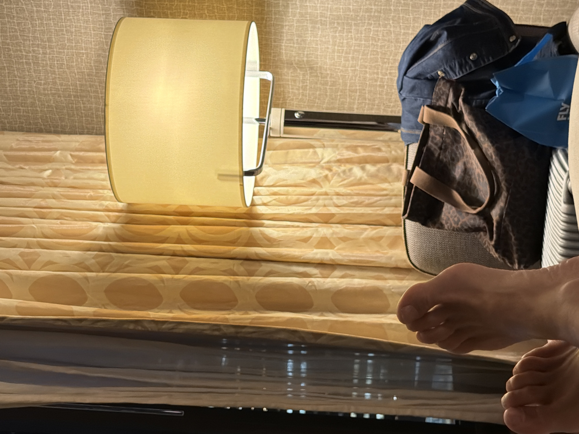 Person rests bare feet in Toronto hotel room