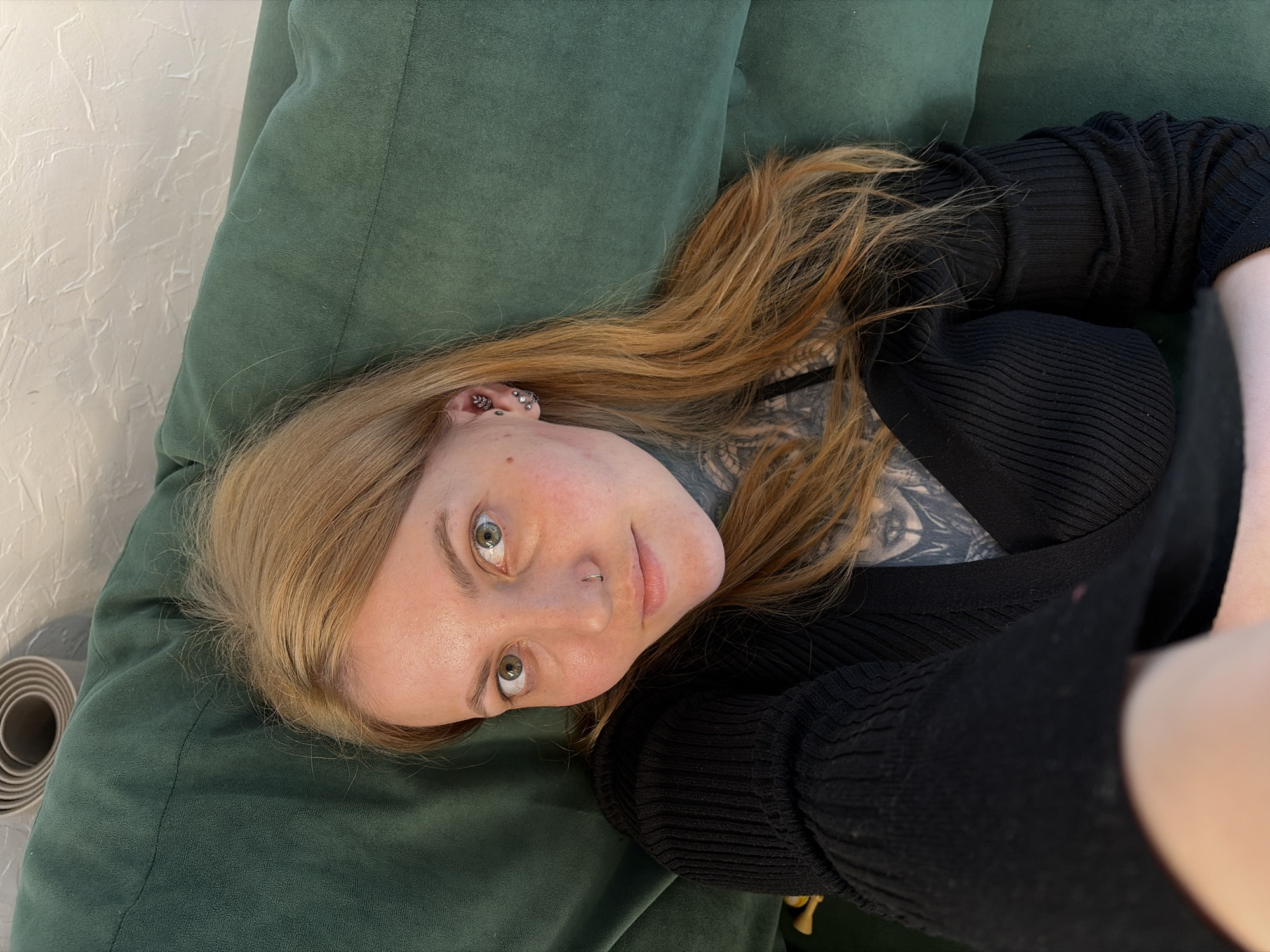 Woman relaxes on green sofa in Russian home