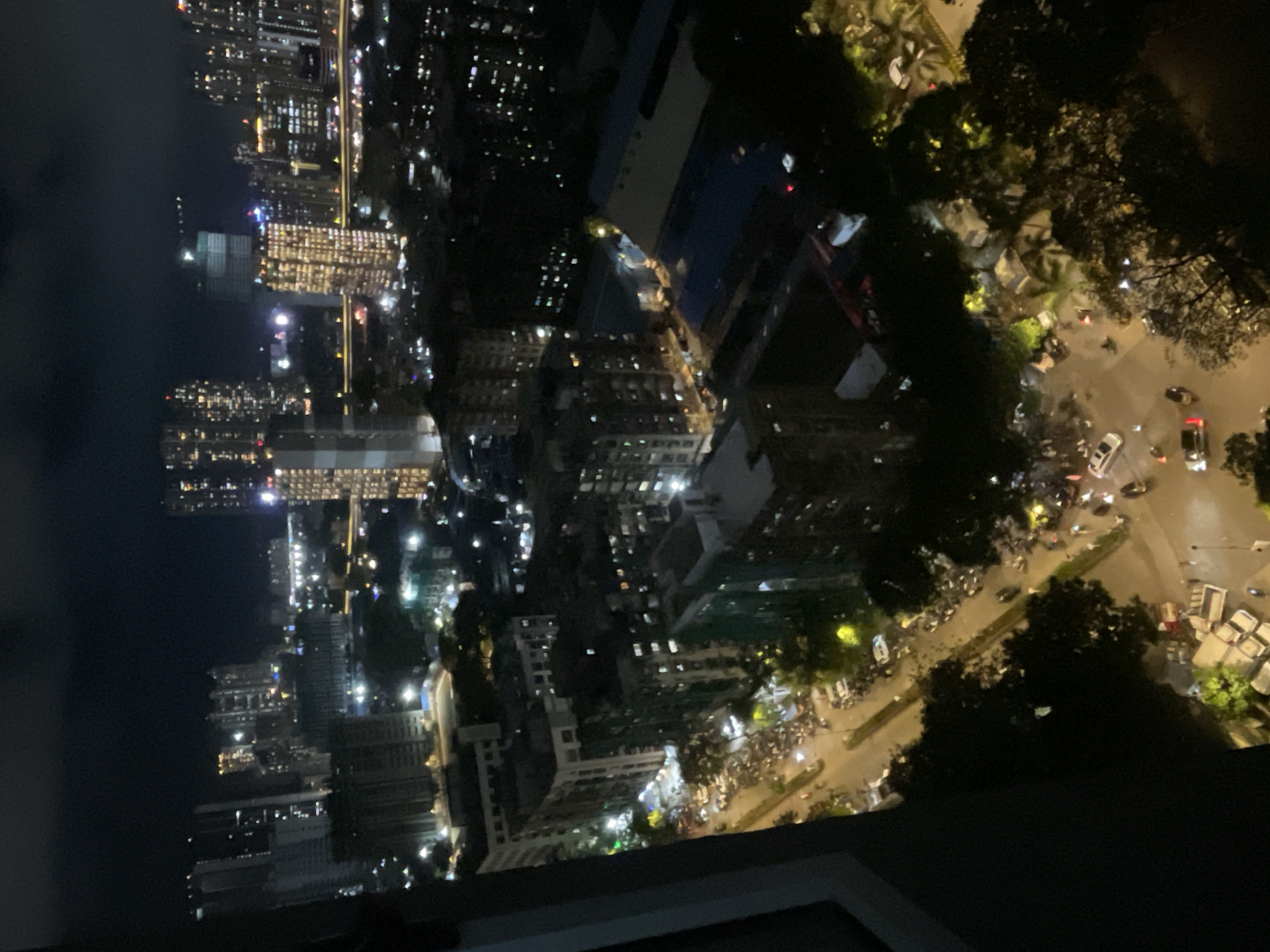 Mumbai high-rise and rooftop pool, cloudy afternoon into dusk