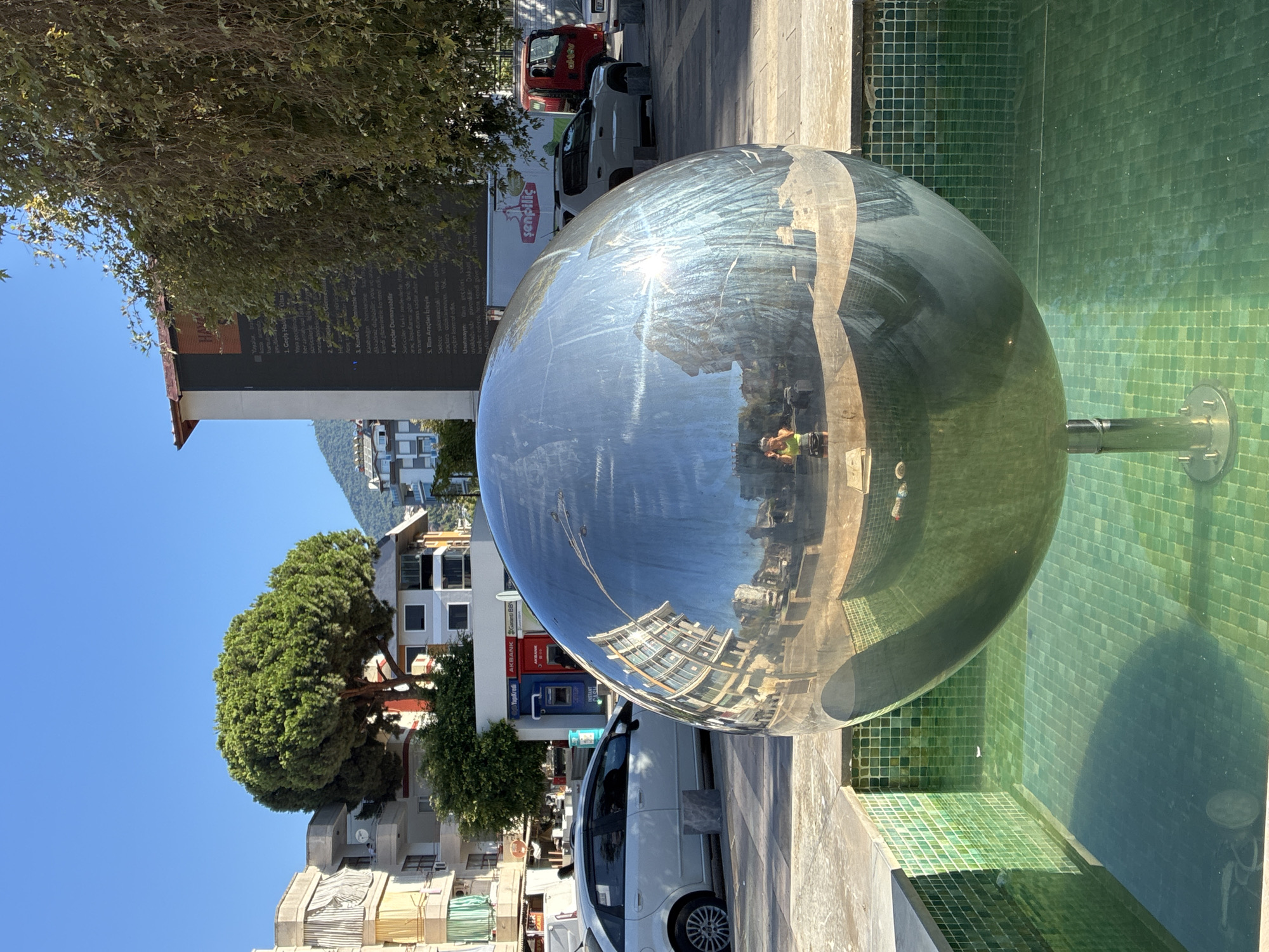 Pigeons and public art fill a sunny Alanya square