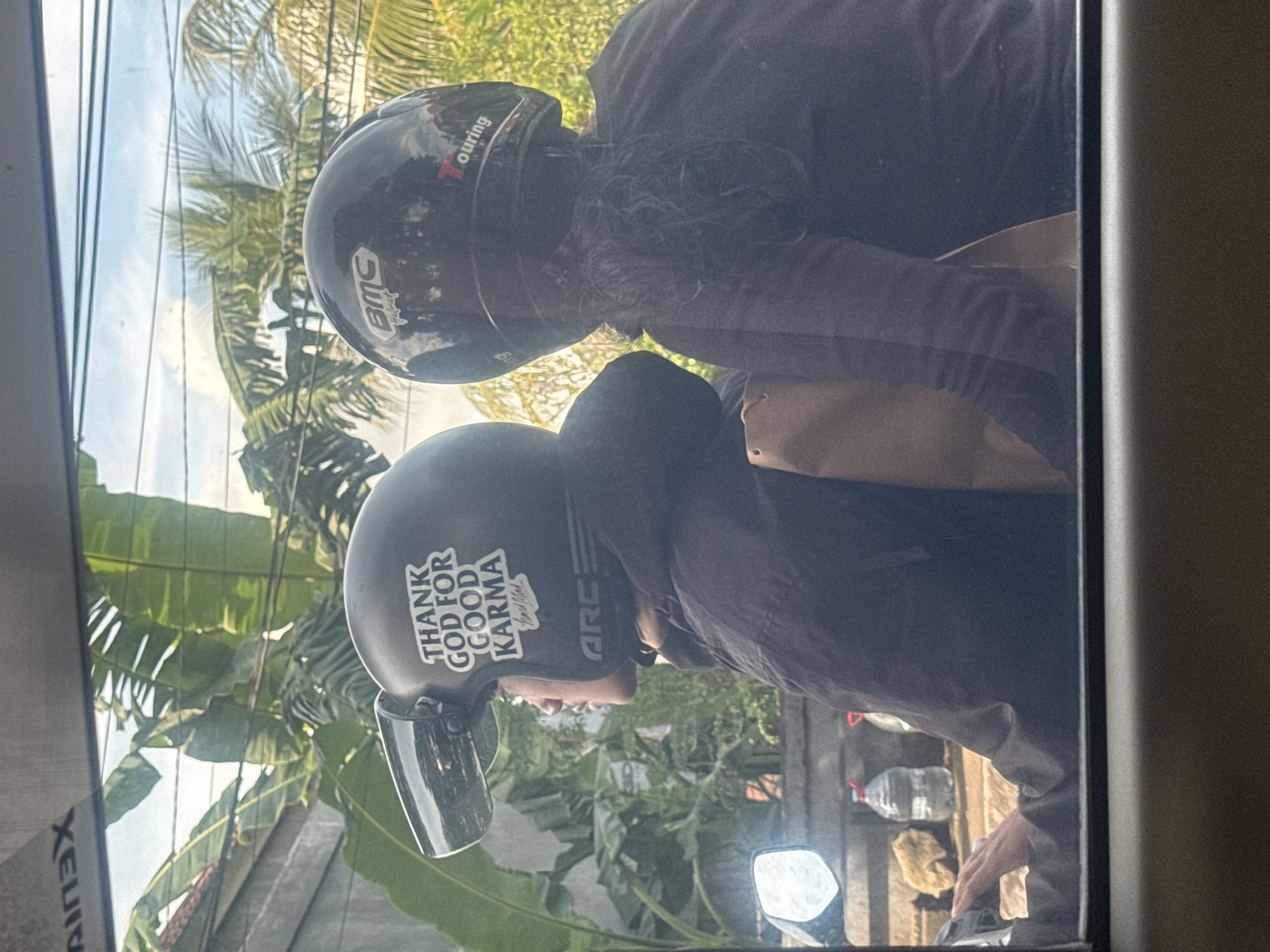 Two scooter riders spotted on Gianyar street through window
