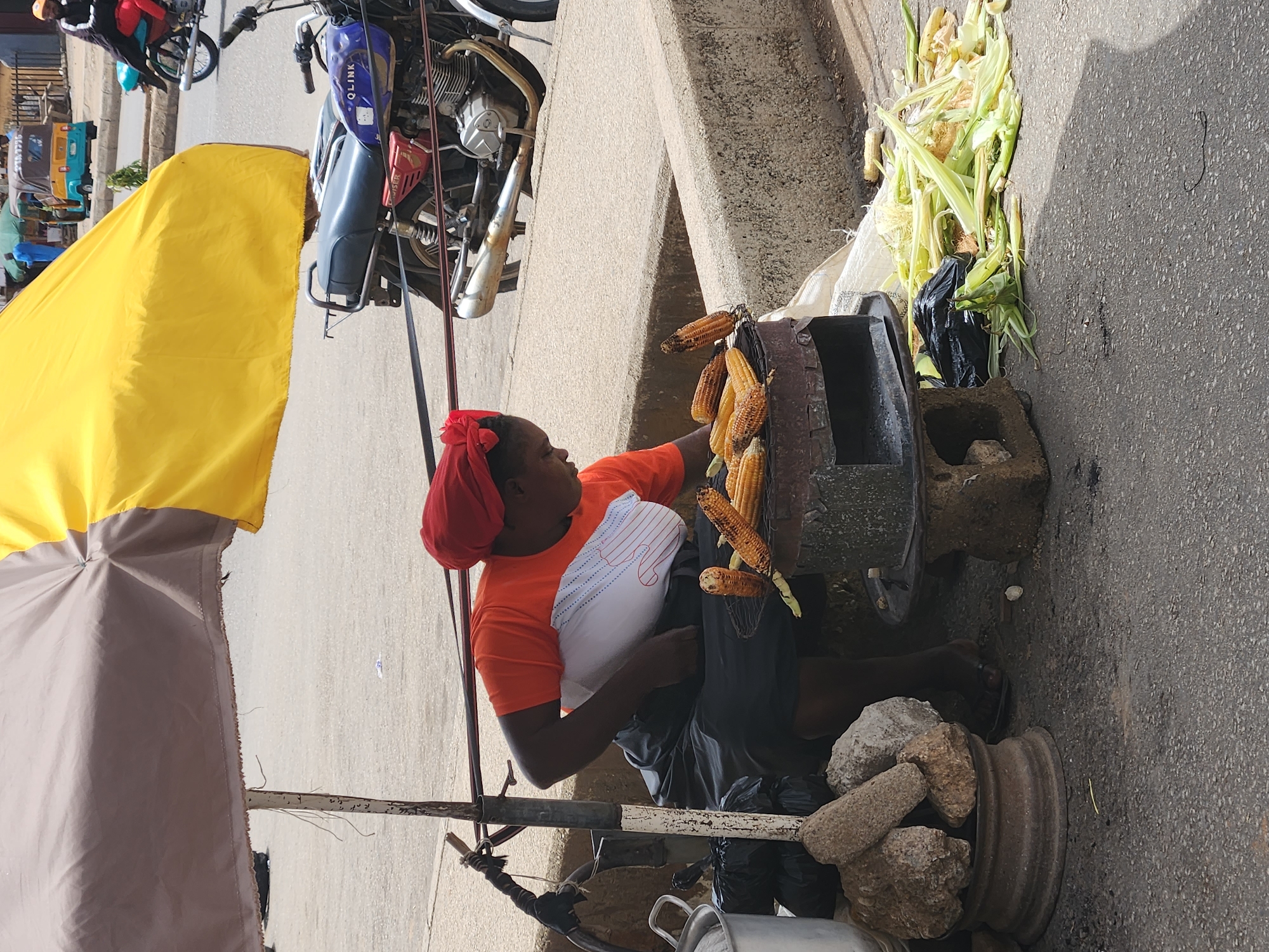 Street vendor sells grilled corn in Kabong, Nigeria