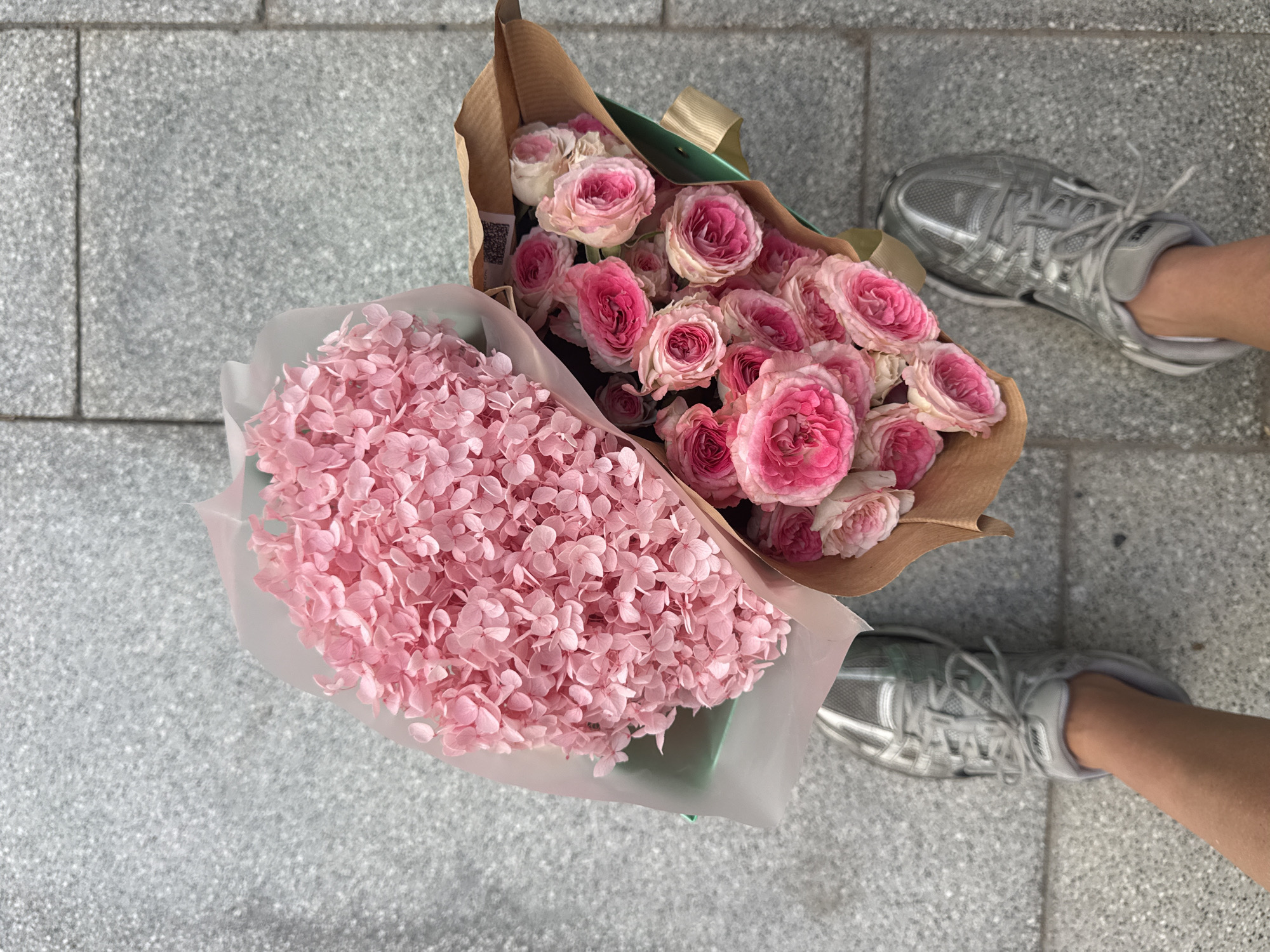 Pink flower bouquets placed on Dubai sidewalk