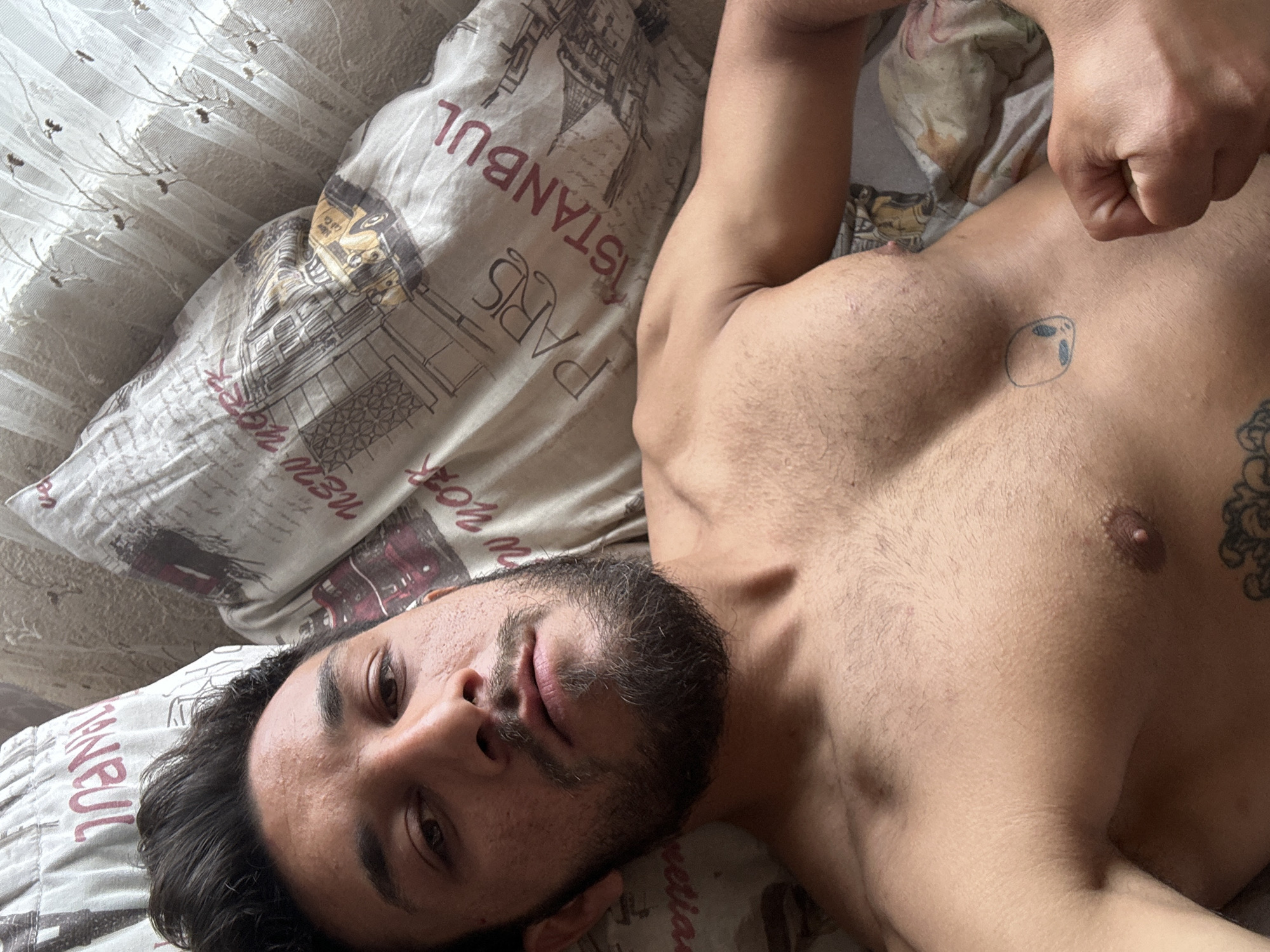 Shirtless man photographed on Eiffel Tower pillow in Bulgaria