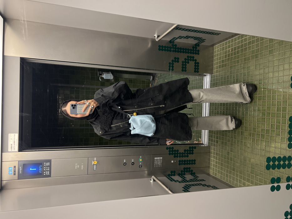 Person takes elevator mirror selfie in Shibuya