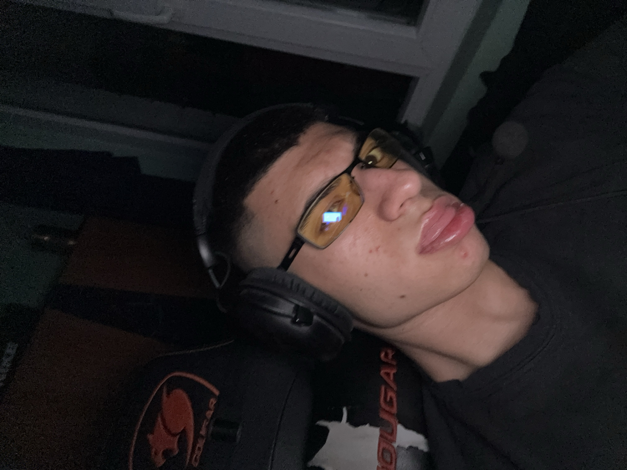 Gamer rests in chair with headphones in Sofia