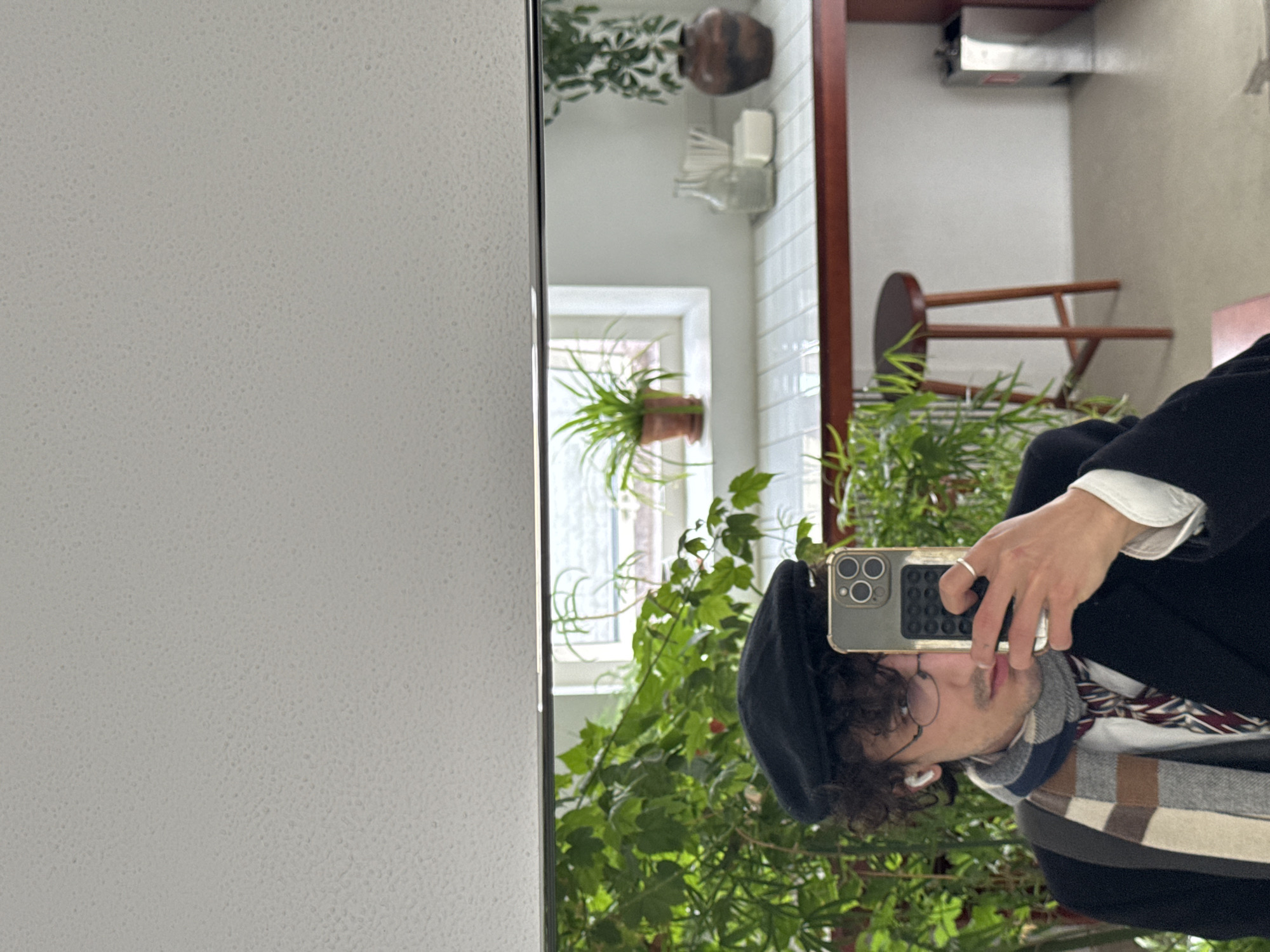 Moscow resident takes mirror selfie in plant-filled room
