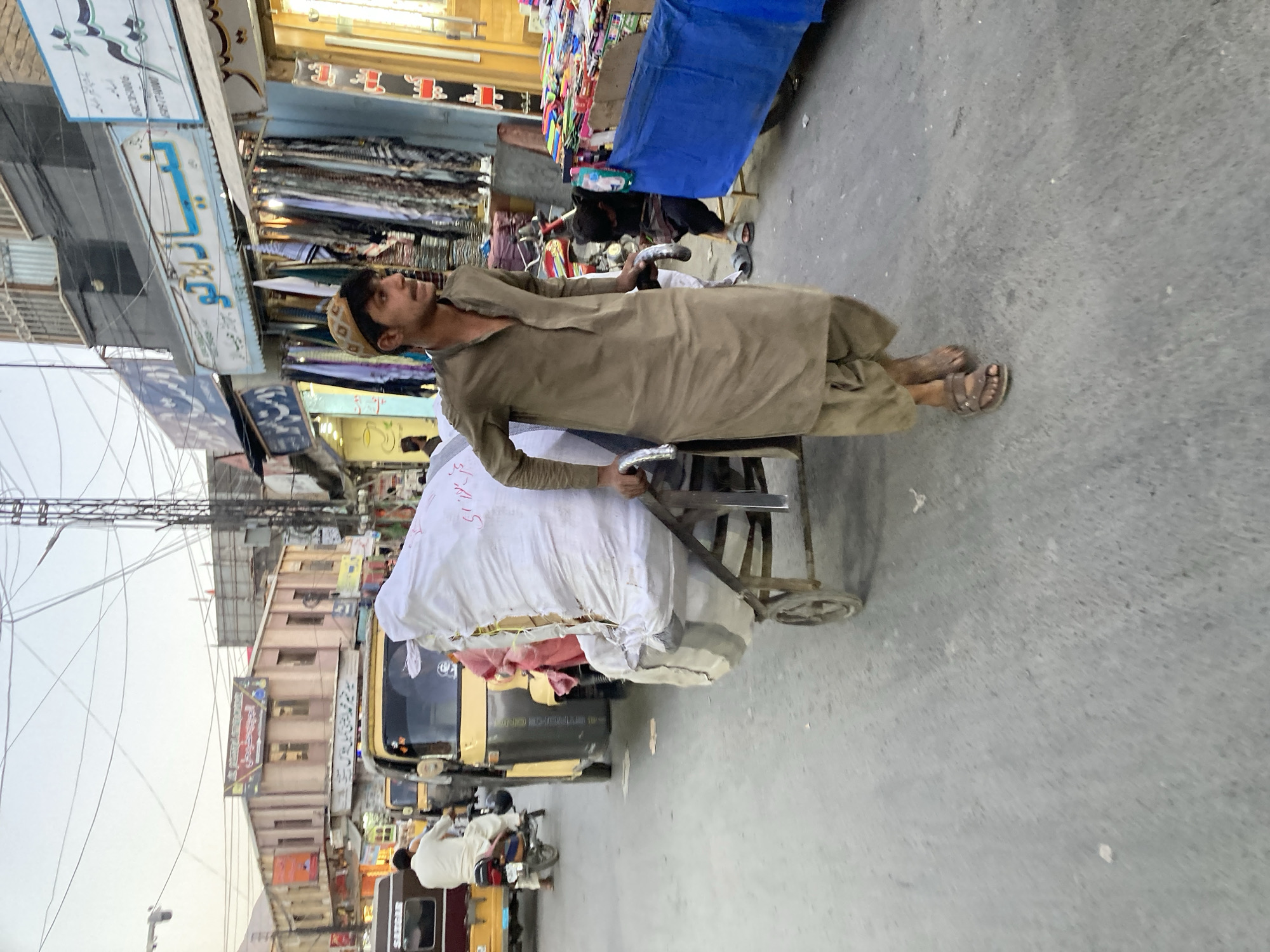 Man pulls package-laden handcart through Quetta streets