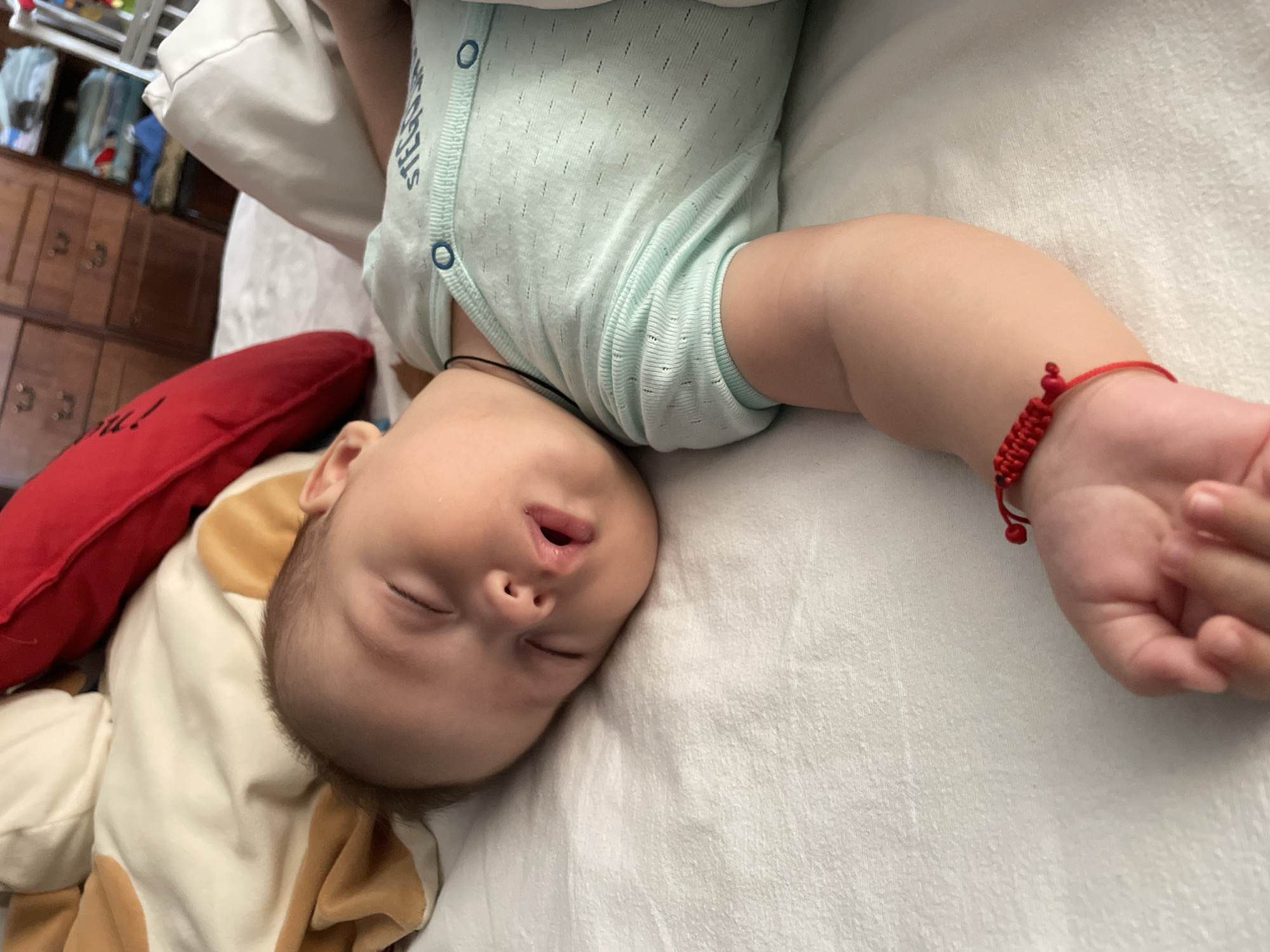 Sleeping baby in light blue onesie, Fălești, Moldova