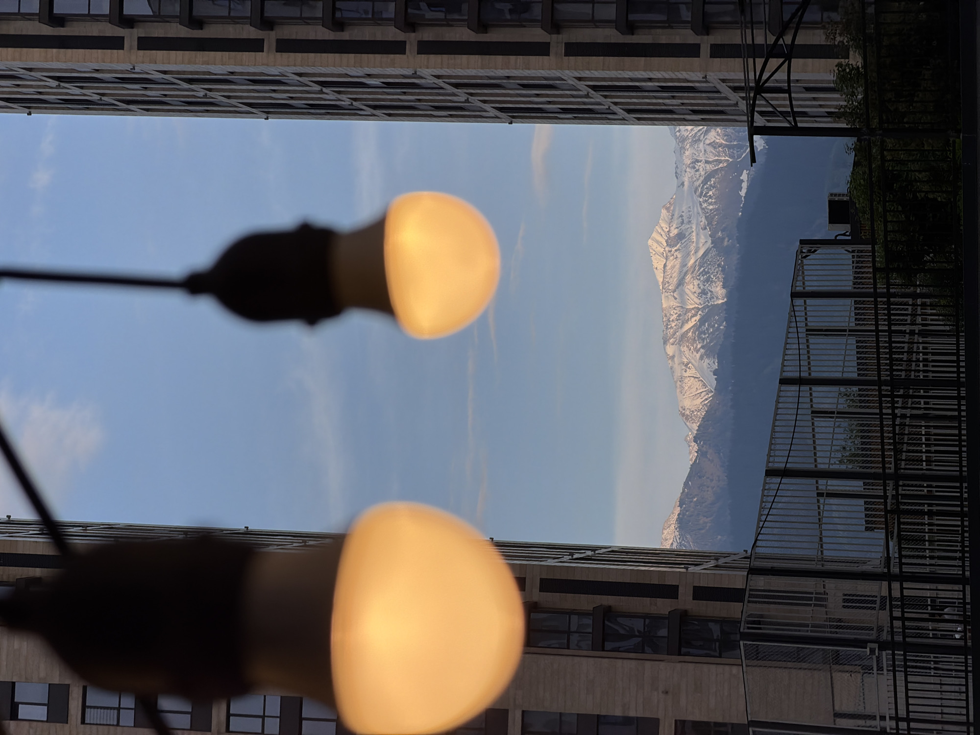 Almaty resident captures Tian Shan mountain views between city buildings