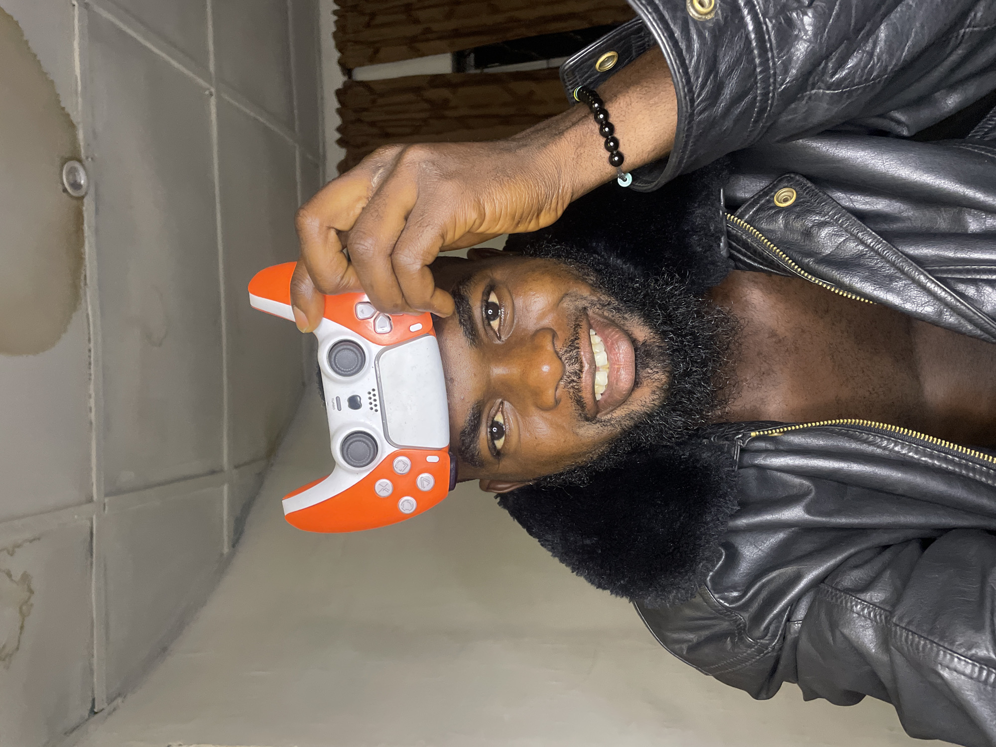Man poses with gaming controllers in Jos photoshoot session