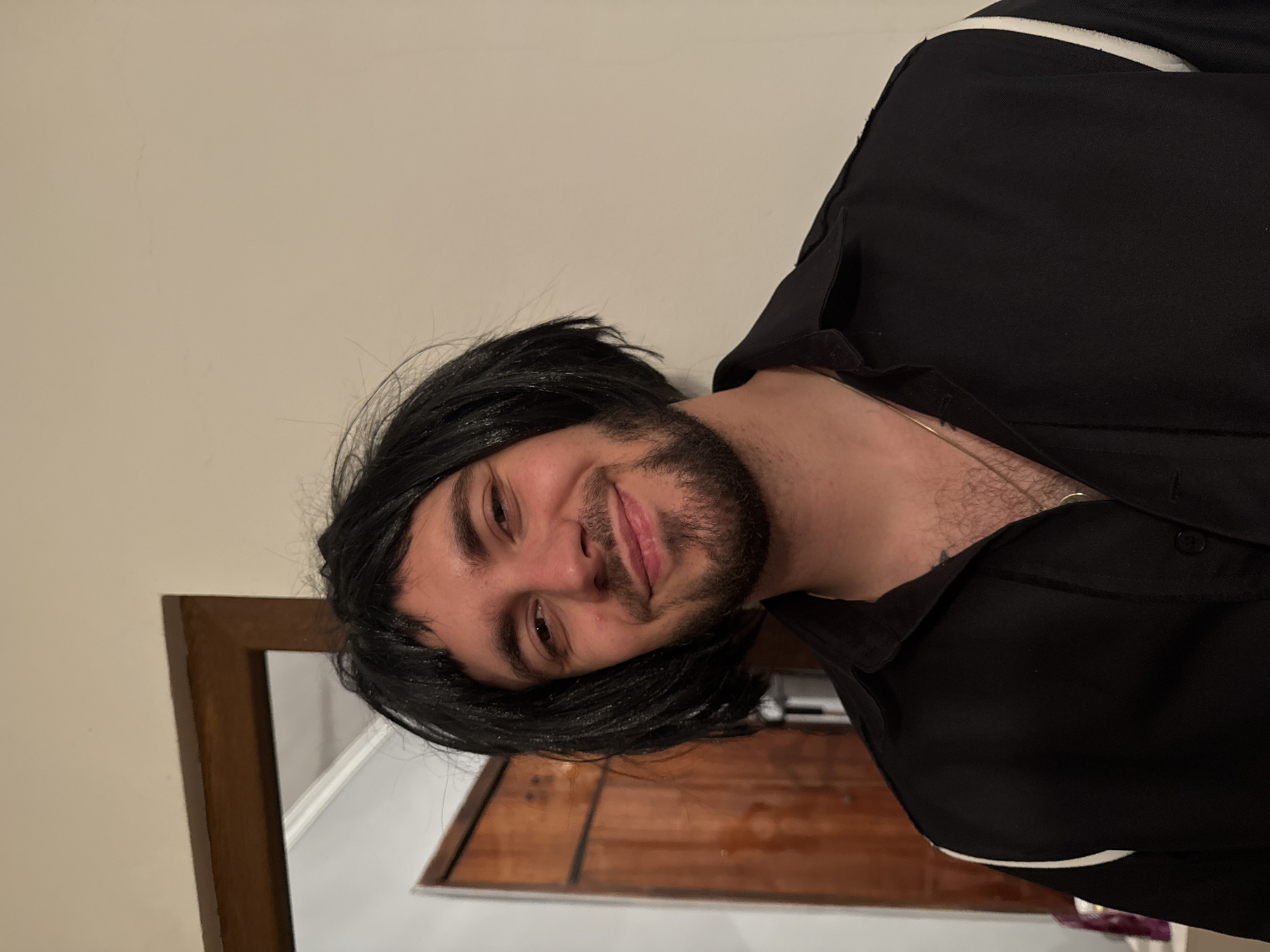 Man in black wig photographed smiling in Yerevan