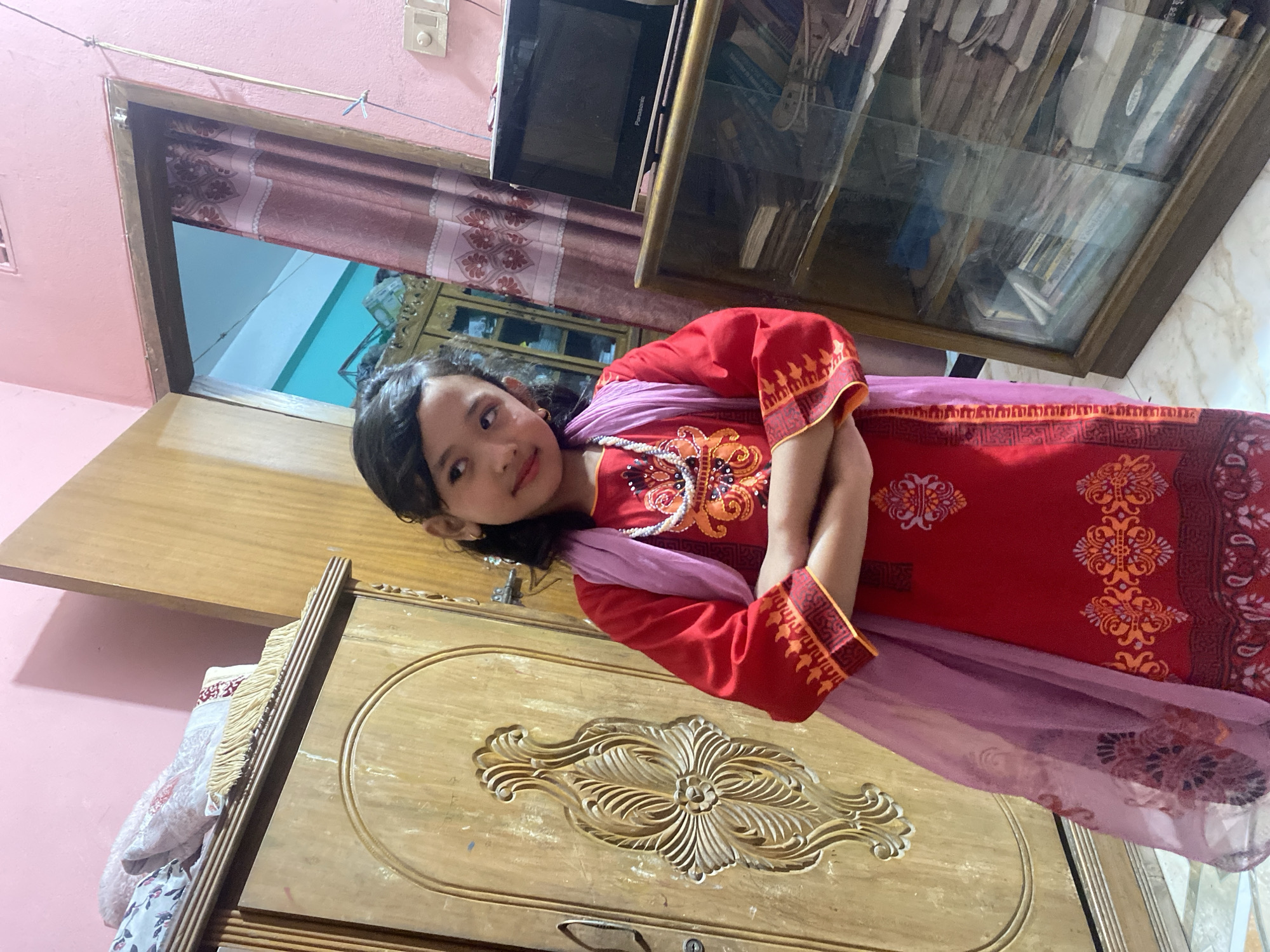 Dancing and posing in traditional dress at a Dhaka home