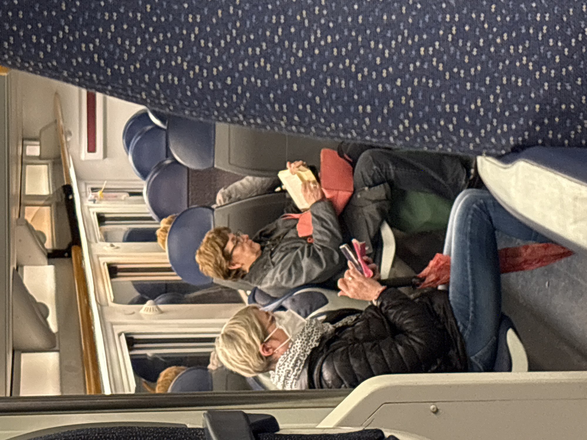 Passengers rest on Milan train during afternoon journey