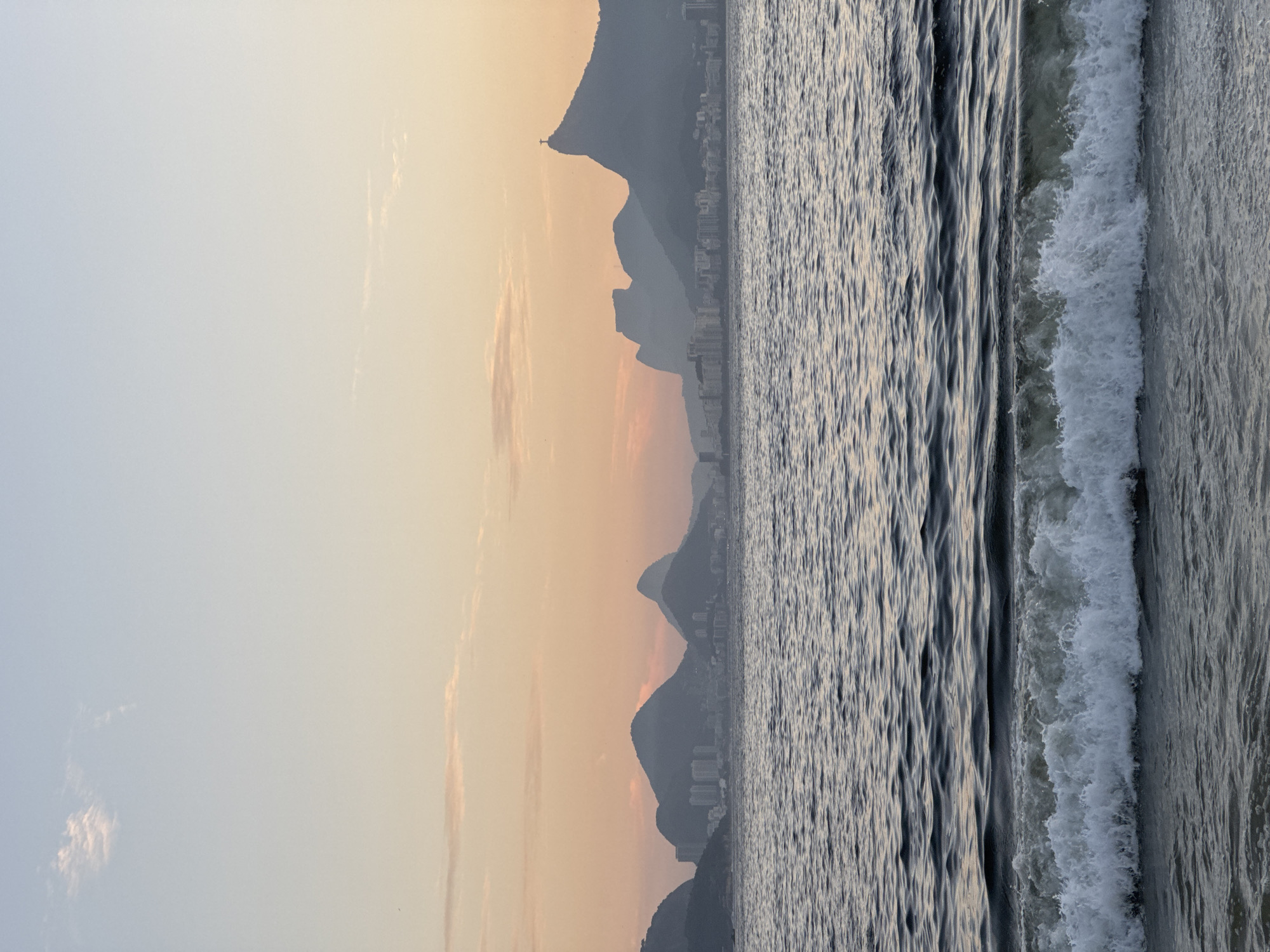 Niterói beach at dusk, Rio's skyline across the water