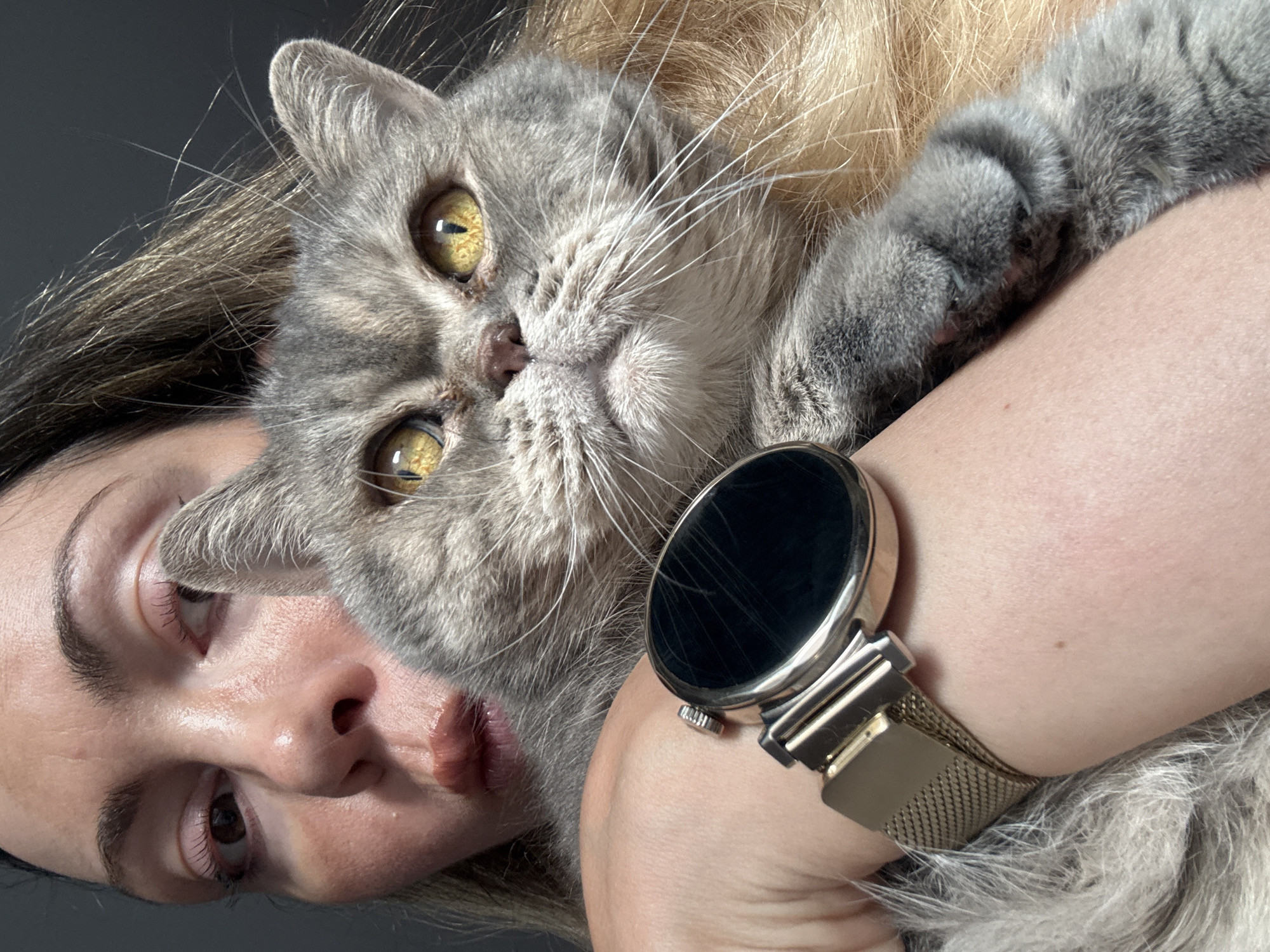 Woman embraces grey cat in intimate portrait in Nesebar
