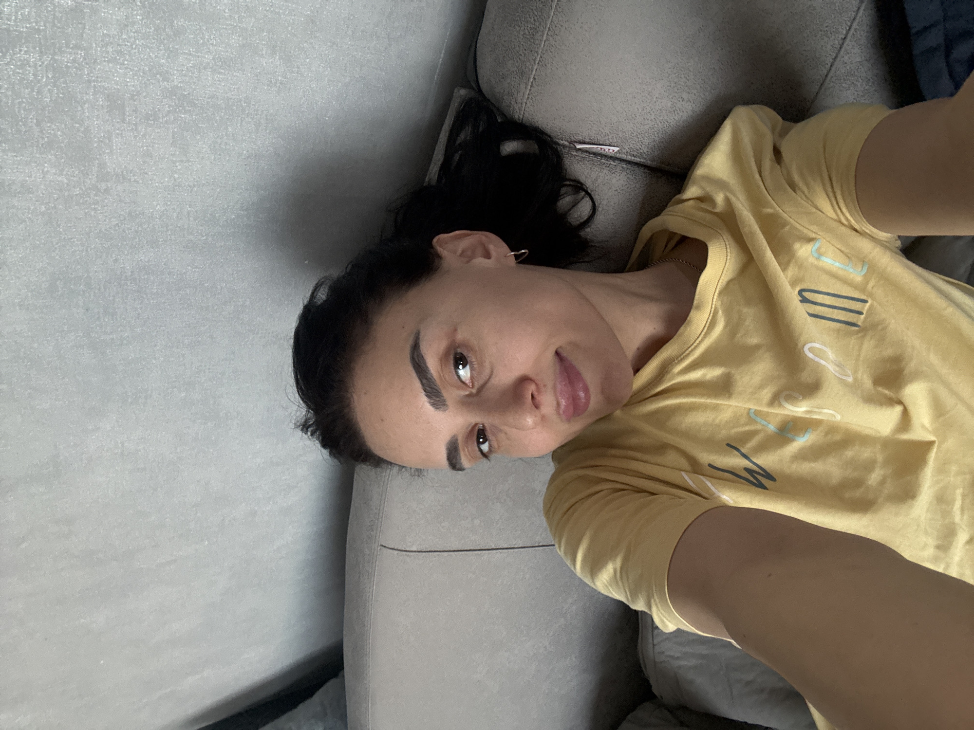 Woman takes selfie on sofa in Tbilisi