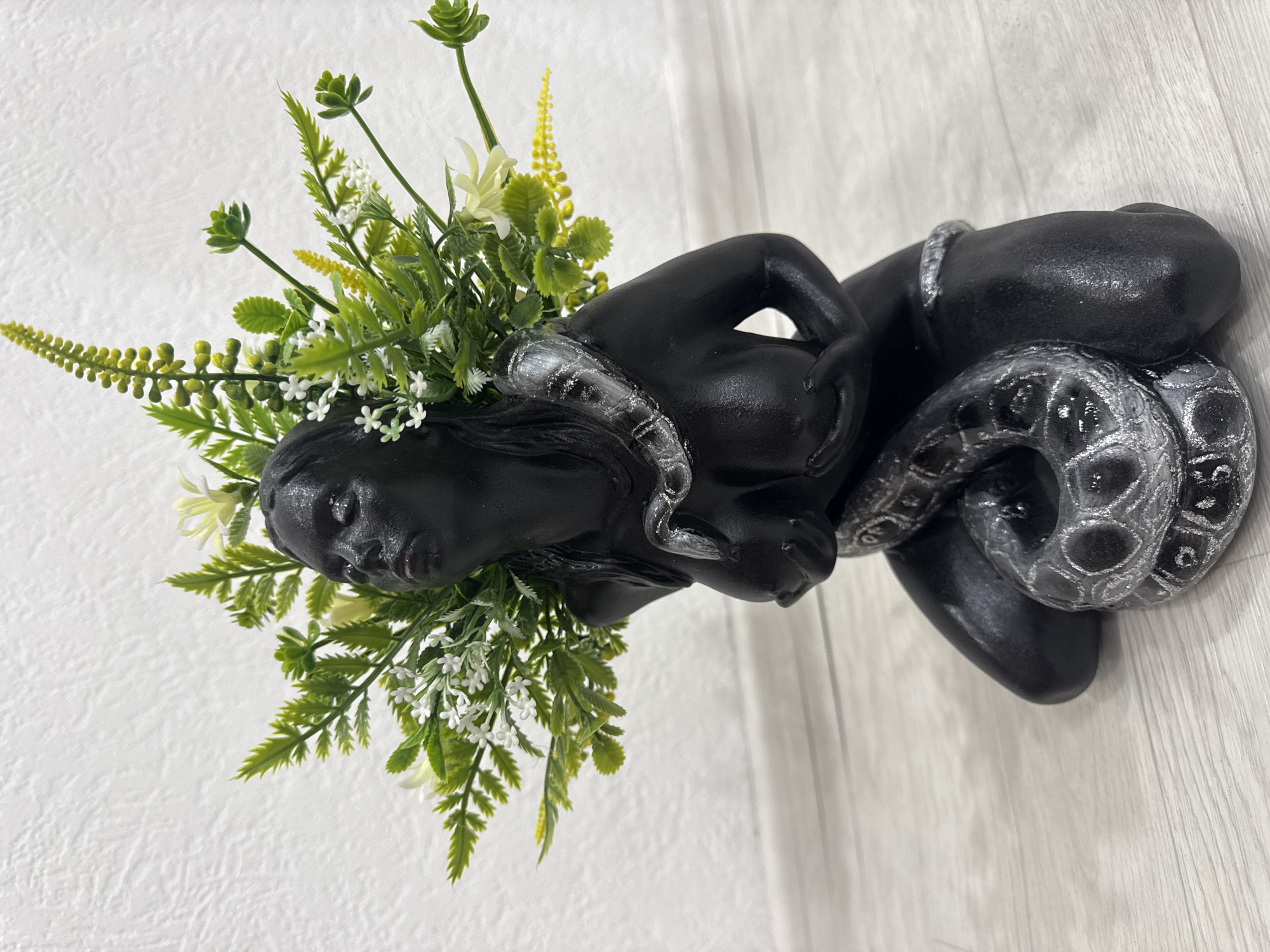 Snake figurines, faux florals, and nail swatches in an Angarsk shop