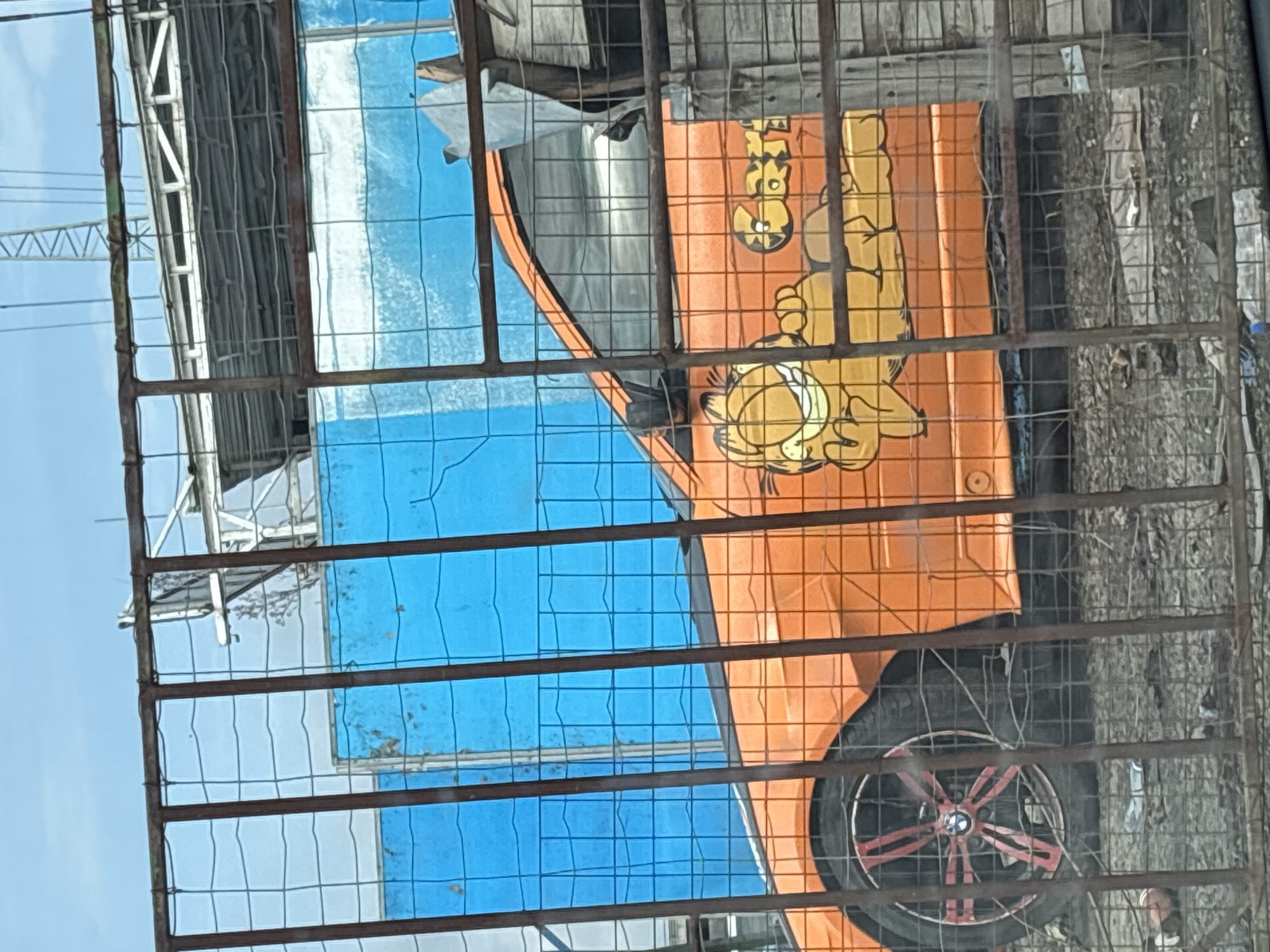 Garfield-decorated orange vehicle spotted behind fence in Burgas
