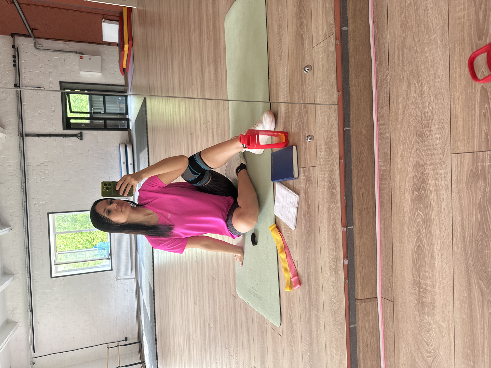 Woman exercises with knee brace at gym morning session