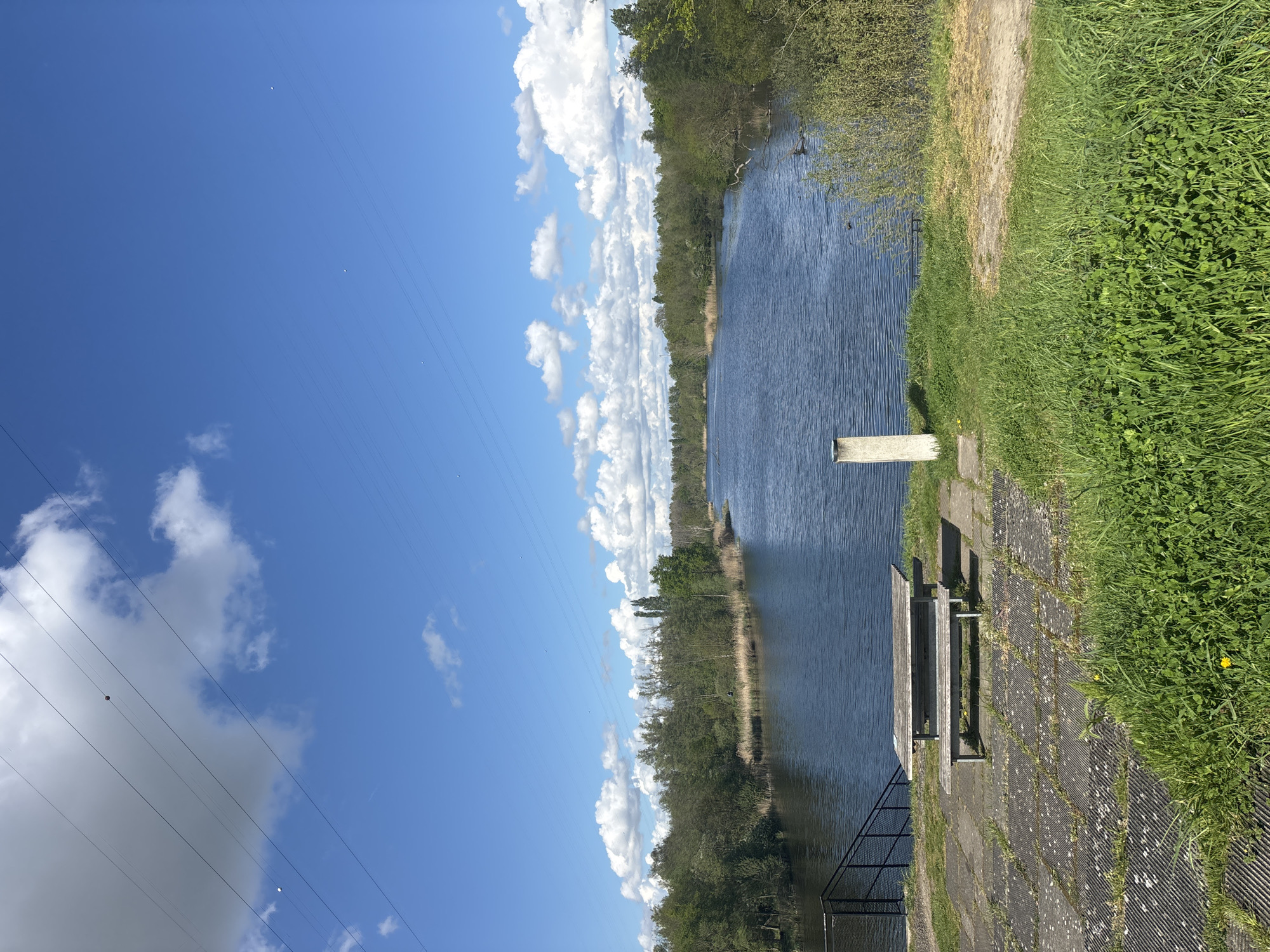Canal observed with walking path and bench in Bazel