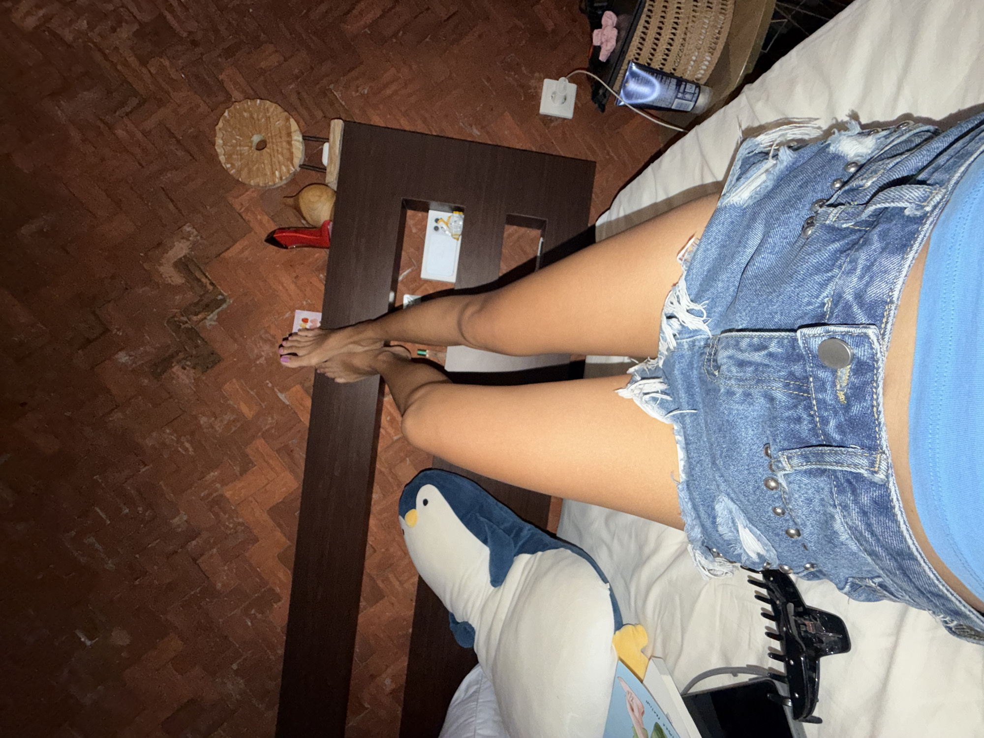 Person relaxing on bed captured in North Kuta interior
