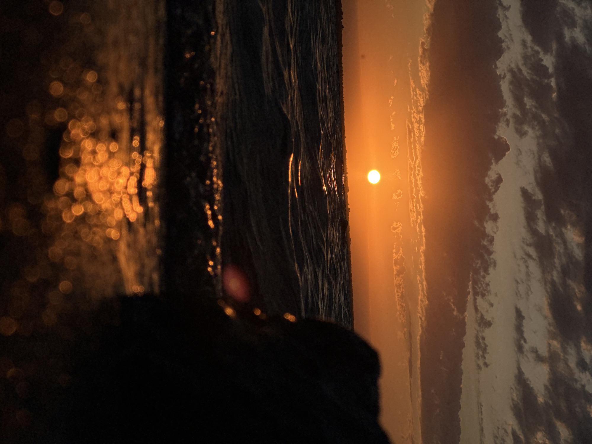 Sunset over a Kokshetau lake, orange light on the water