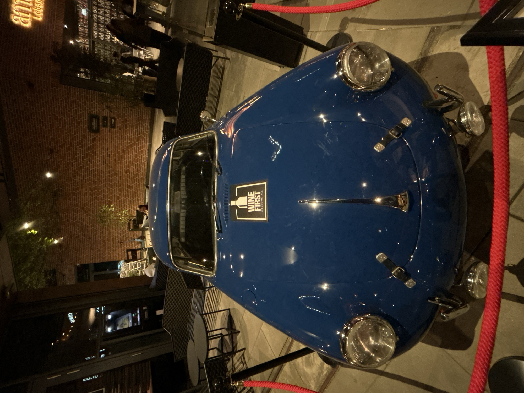 Vintage car display outside Warsaw restaurant draws evening attention