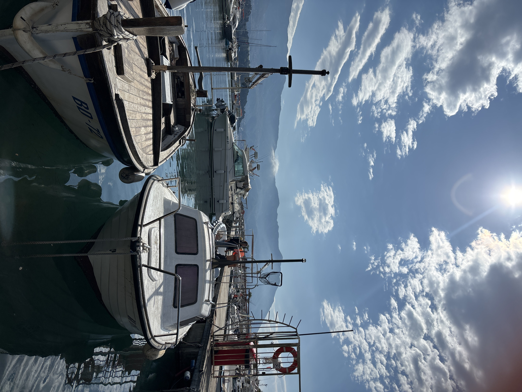Woman takes selfies at Budva marina on sunny morning