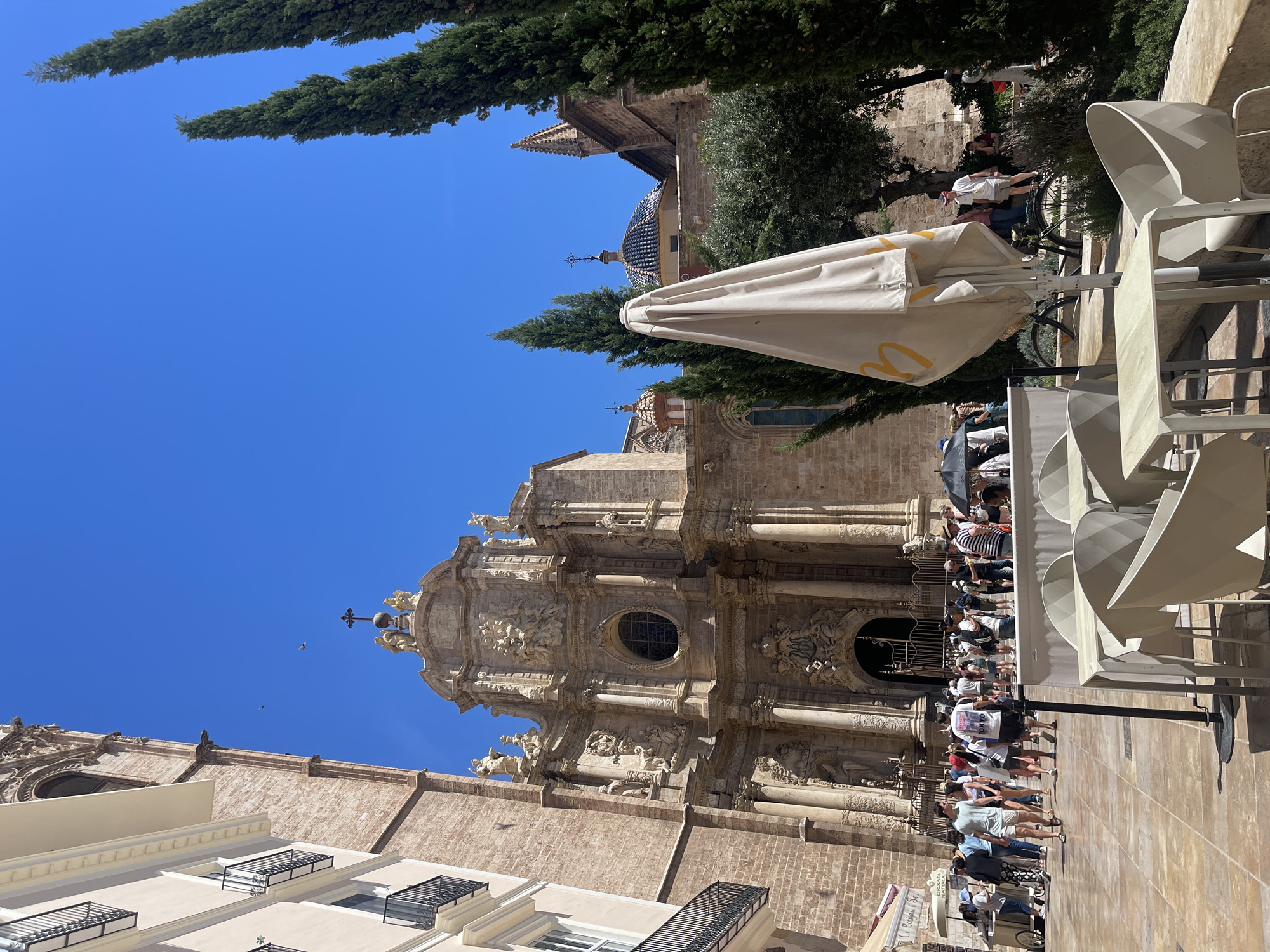 Tourists gather at Valencia Cathedral for ice cream and street performances
