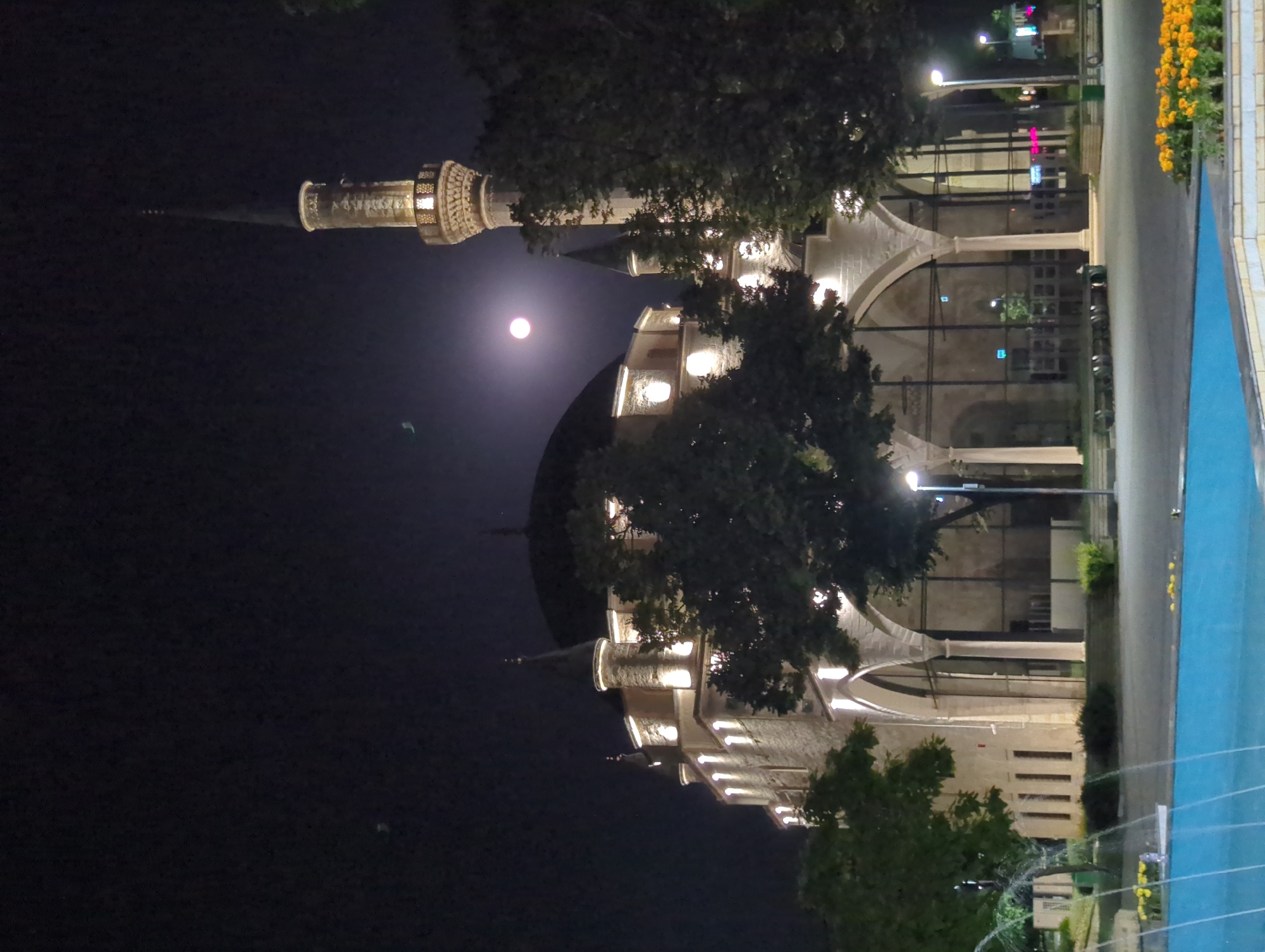 Ibrahim Pasha Mosque lit up under a full moon in Razgrad