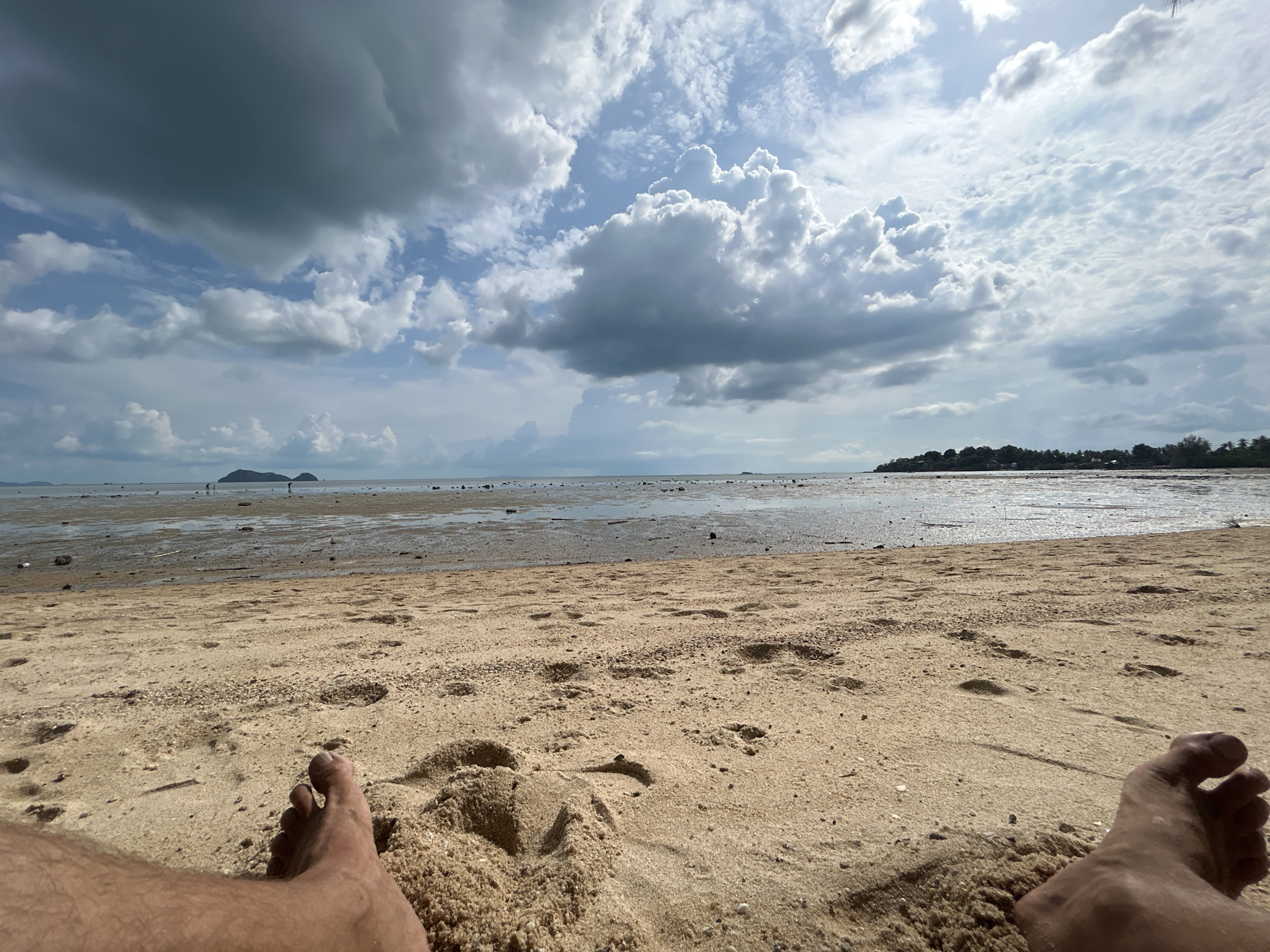 Low tide reveals expansive mudflats at Thai beach