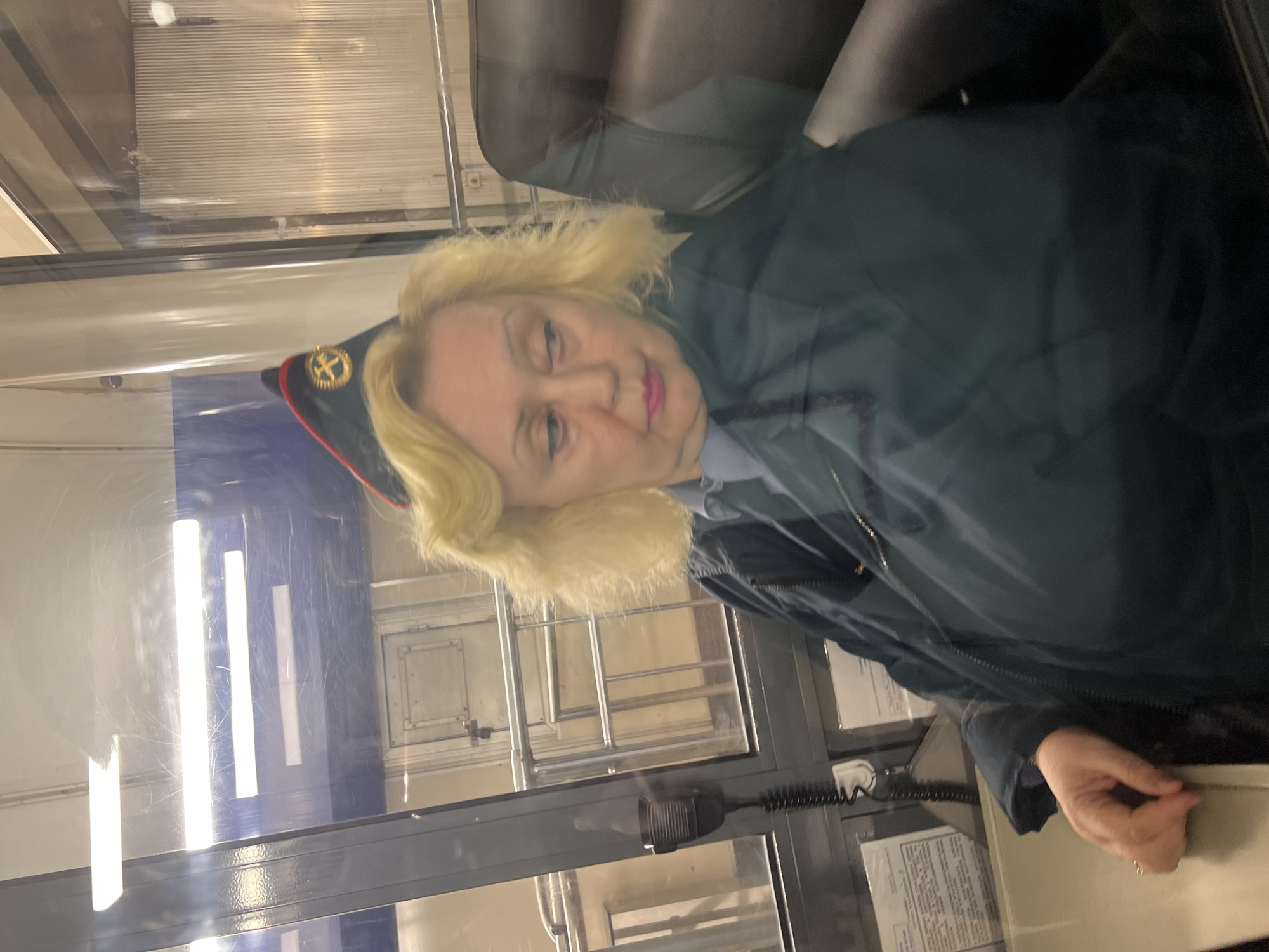 Woman in uniform observed behind glass window